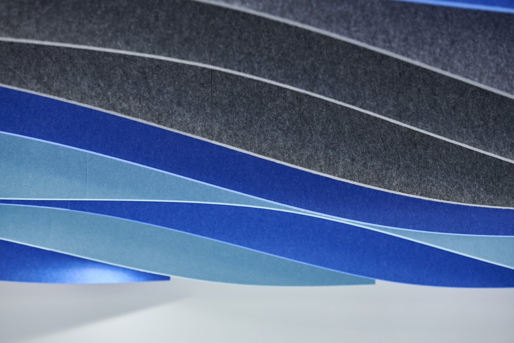 undulating ceiling panels reflecting water