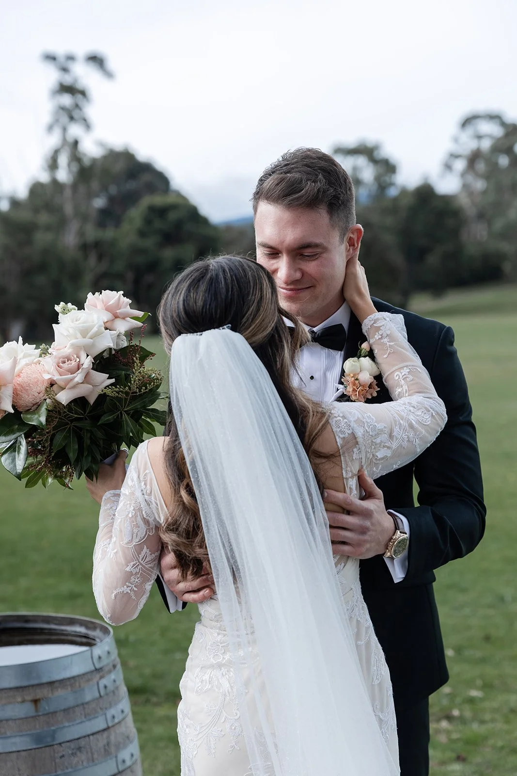 A groom smiles down at his bride after seeing her for the first time on their wedding day at Immerse in the Yarra Valley, Melbourne.