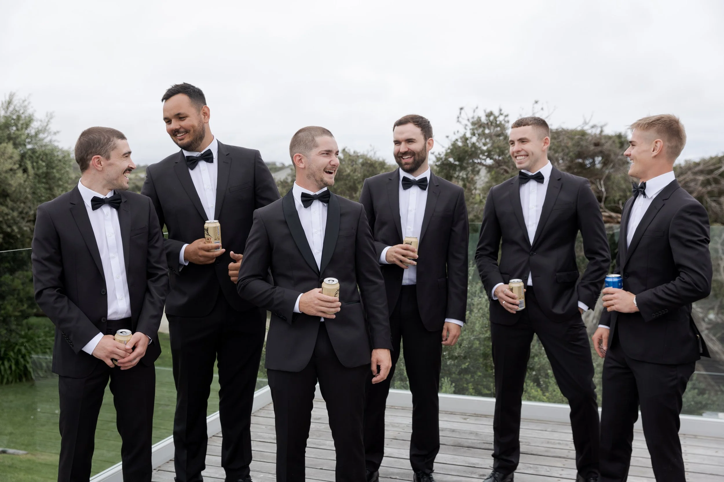 A groom laughs with his groomsmen on the morning of his wedding in Portsea, Melbourne.
