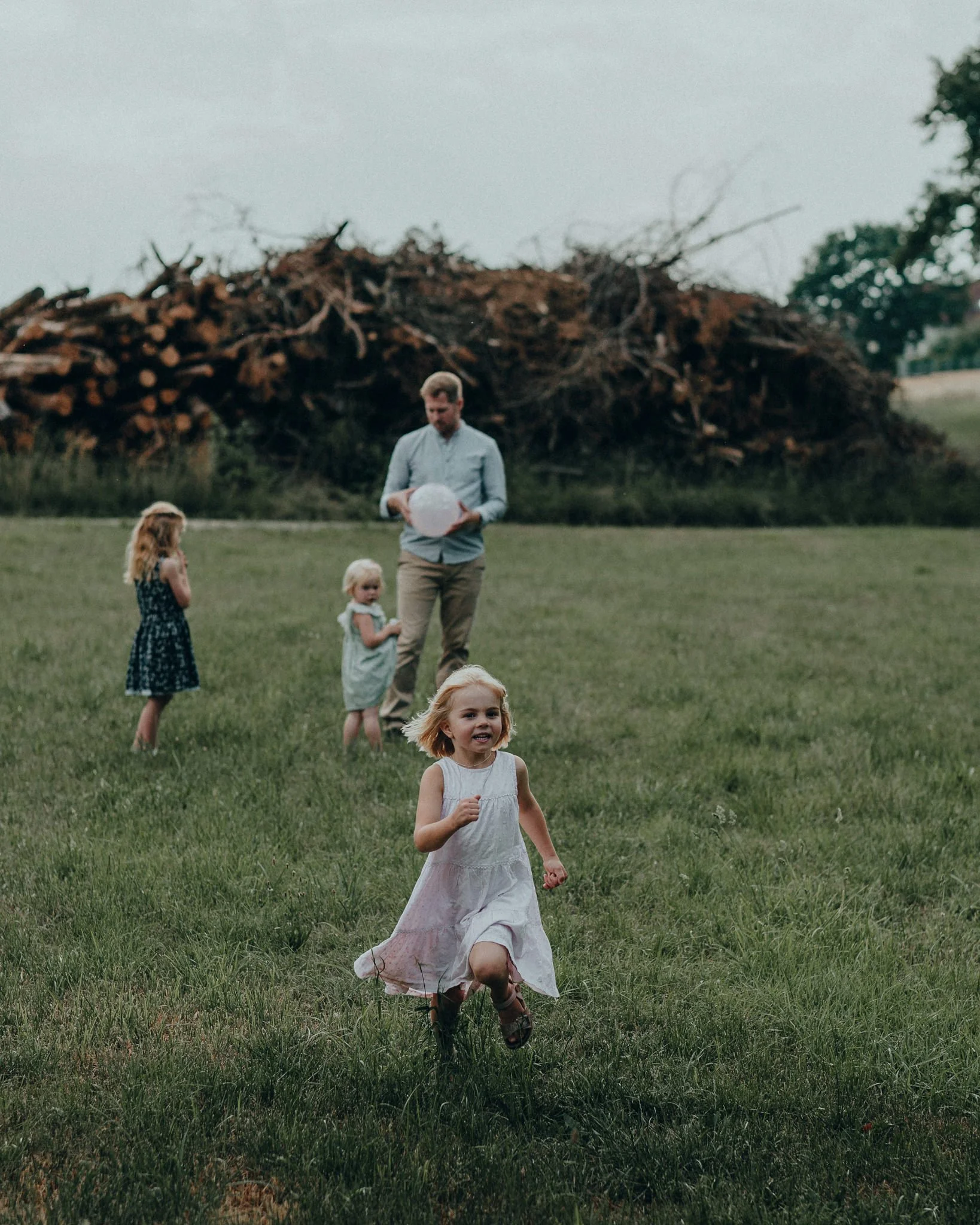 Eine Dinosaurier-Skulptur im Freien mit Kindern und einem Erwachsenen im Vordergrund.