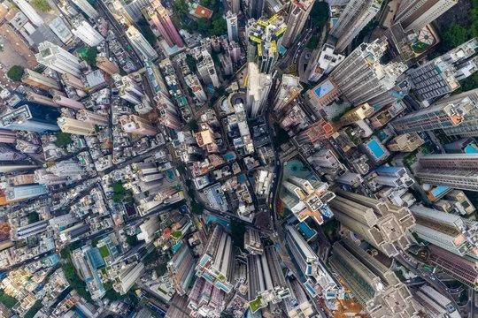 Aerial view of a dense cityscape with numerous tall skyscrapers and buildings.