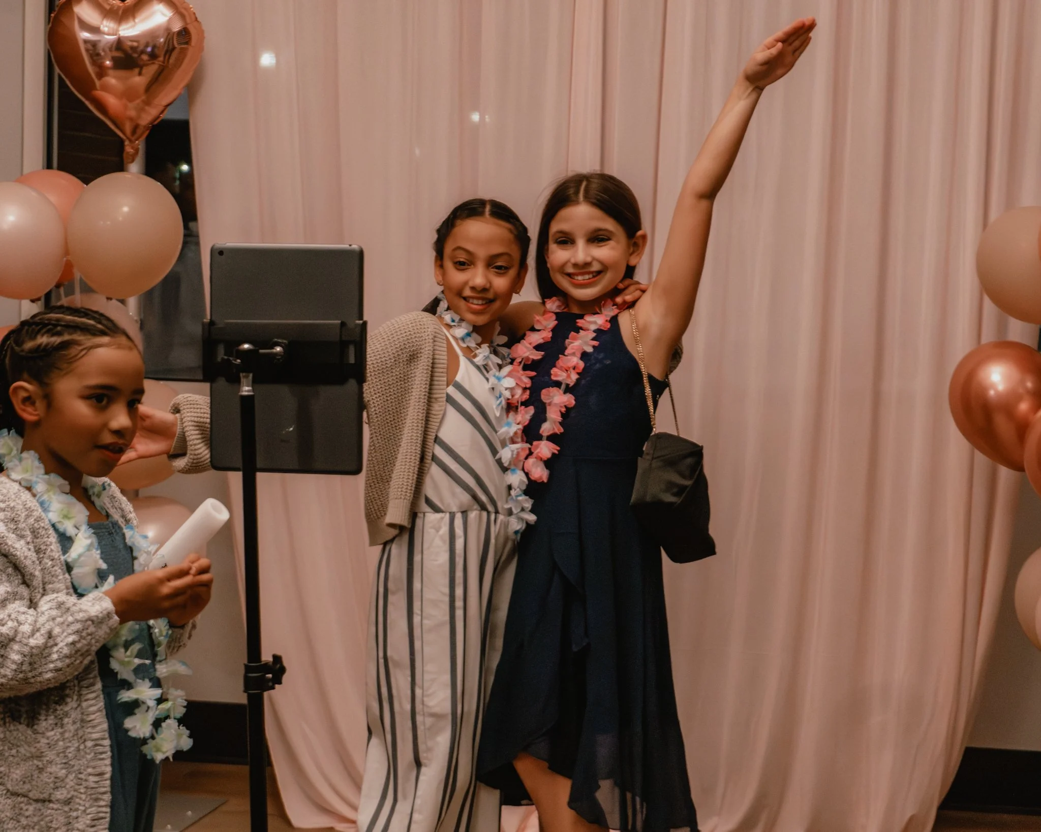 Girls posing for photos at the Daddy Daughter Dance photo booth at Abundant Life Church in Wilmington Massachusetts.