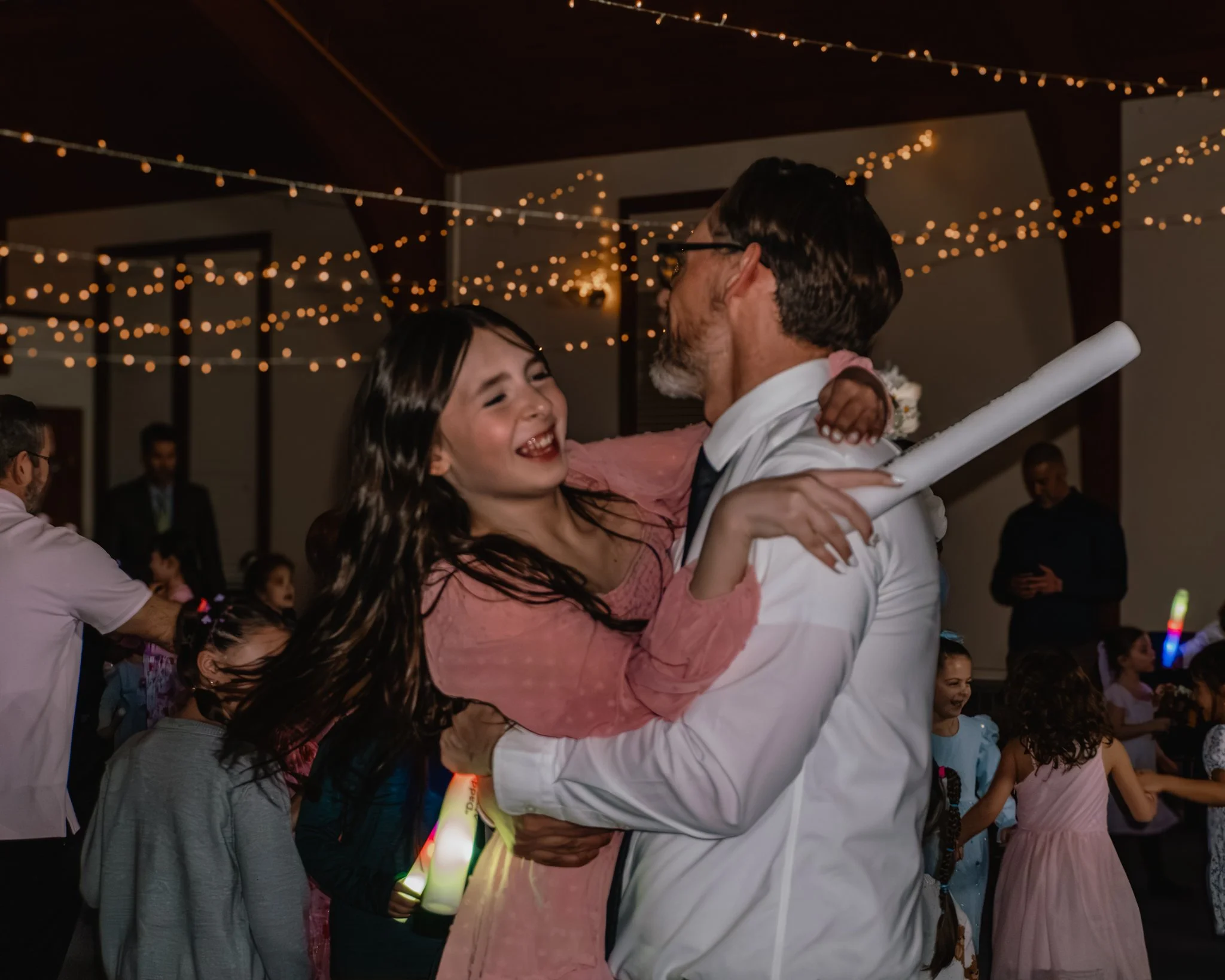 Father lifting and dancing with his daughter during the Daddy Daughter Dance at Abundant Life Church in Wilmington MA.