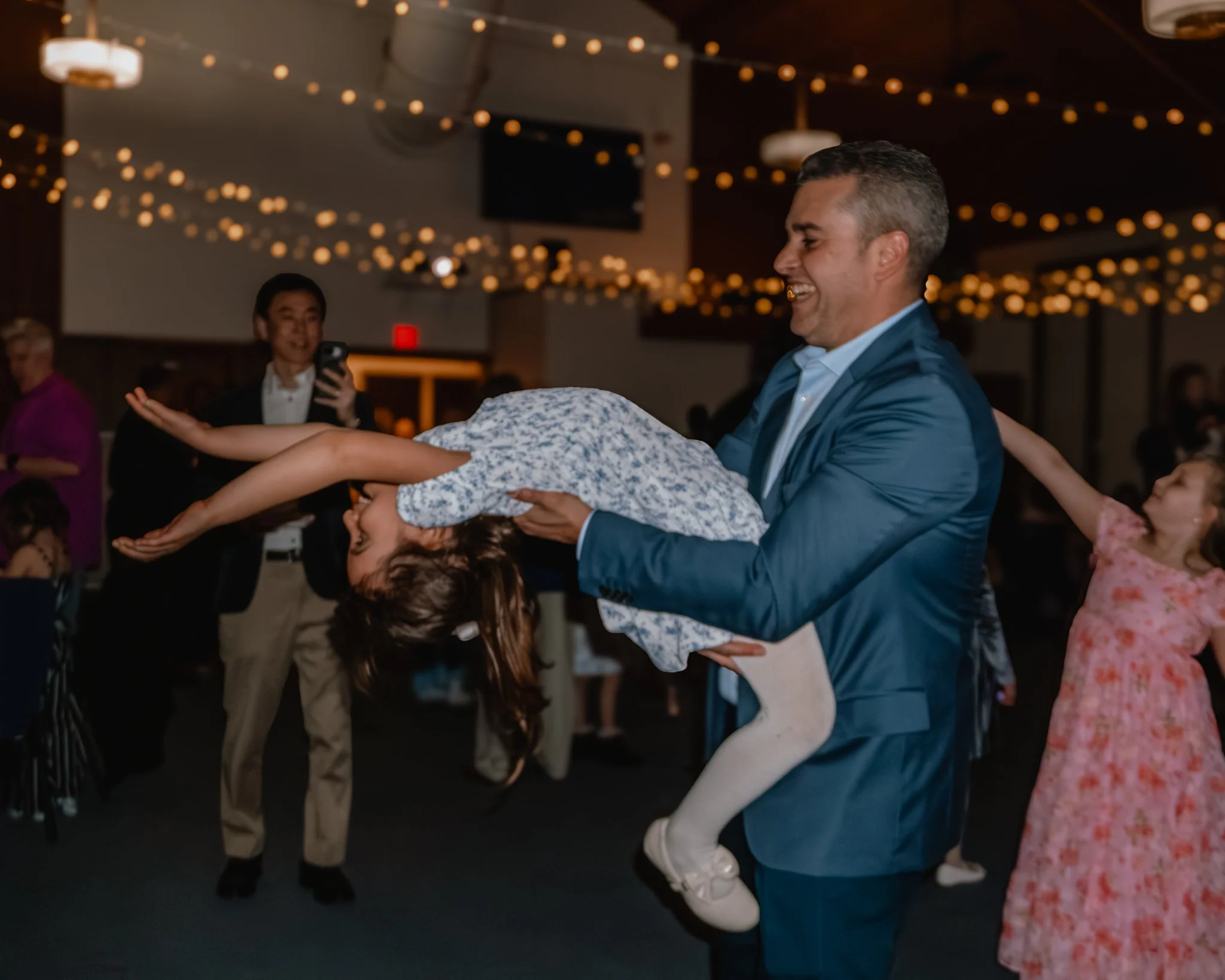 Father spinning his daughter on the dance floor during the Daddy Daughter Dance at Abundant Life Church in Wilmington MA.