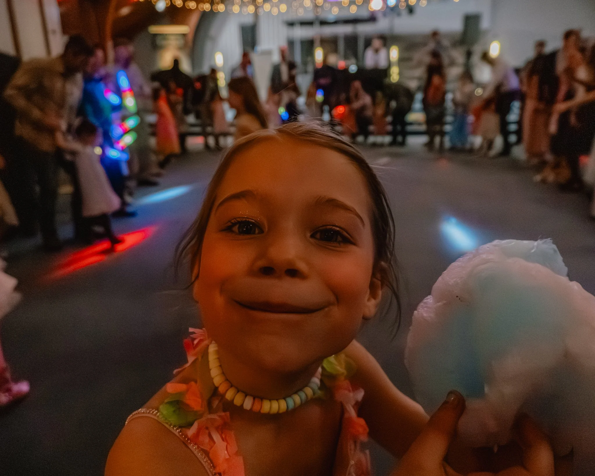 Young girl enjoying cotton candy at the Daddy Daughter Dance at Abundant Life Church in Wilmington Massachusetts.