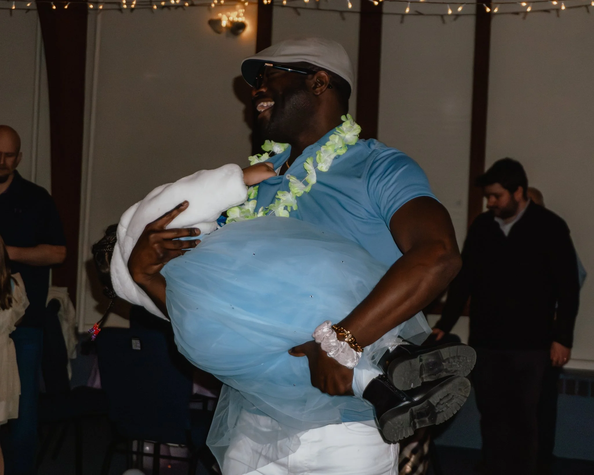 Father lifting his daughter while dancing at the Daddy Daughter Dance at Abundant Life Church in Wilmington Massachusetts.