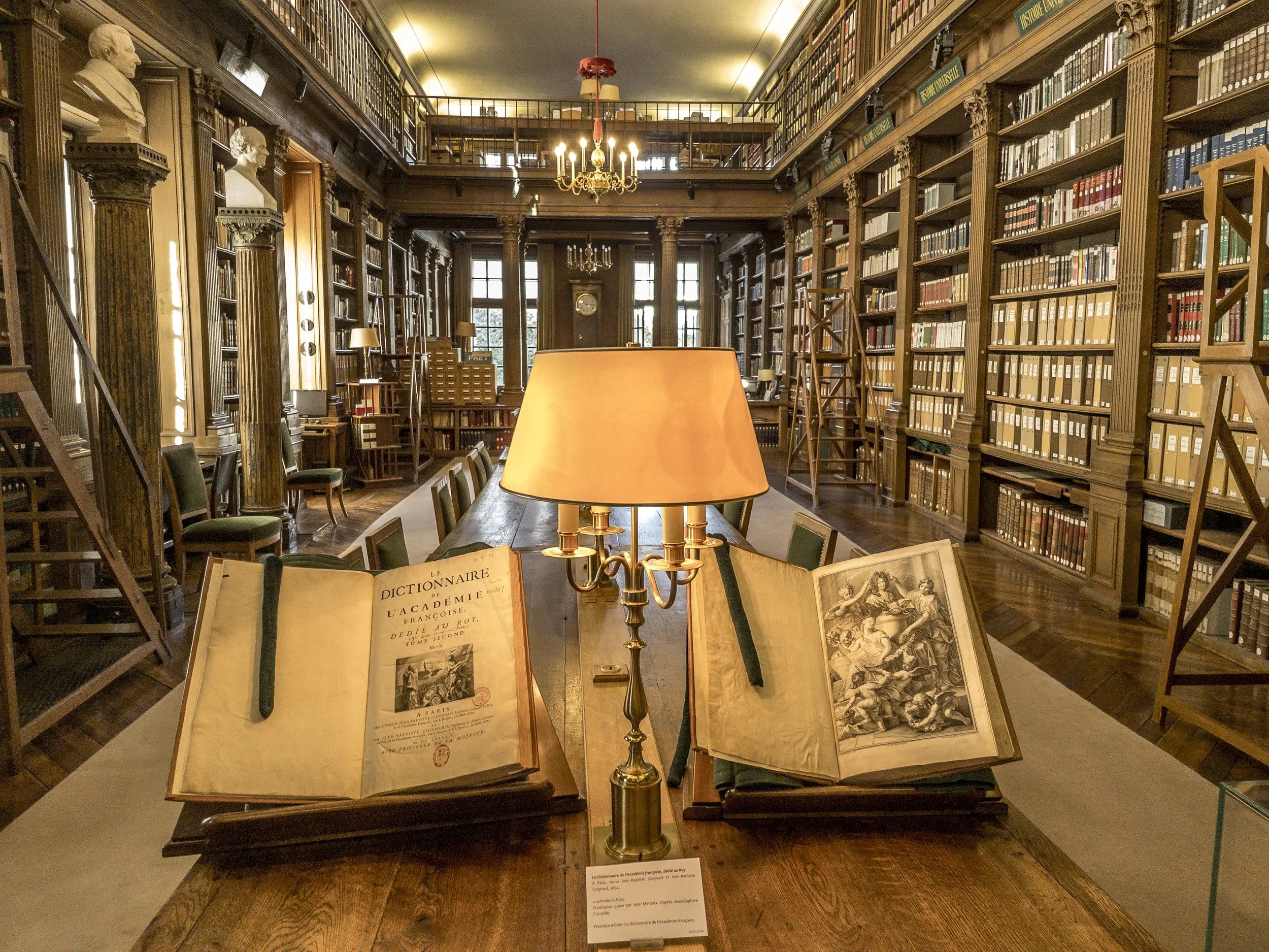 Intérieur de la bibliothèque de l'Institut de France avec boiseries, dictionnaire ancien de l'Académie et lampe de lecture - Photo Théo Castillon