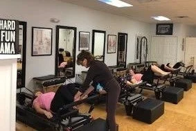 Pilates instructor teaching a class