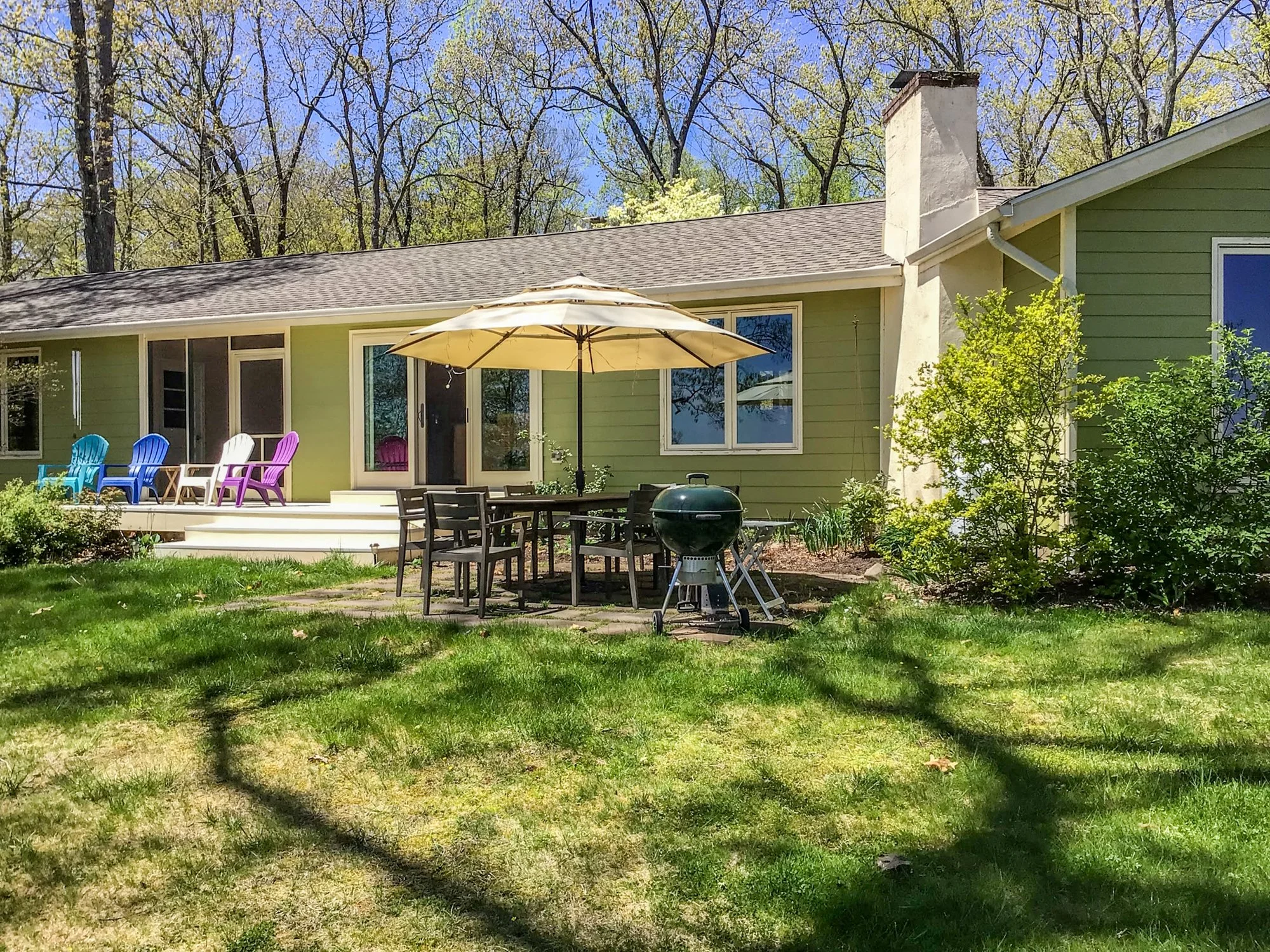 Back of house deck and patio in Spring.jpg