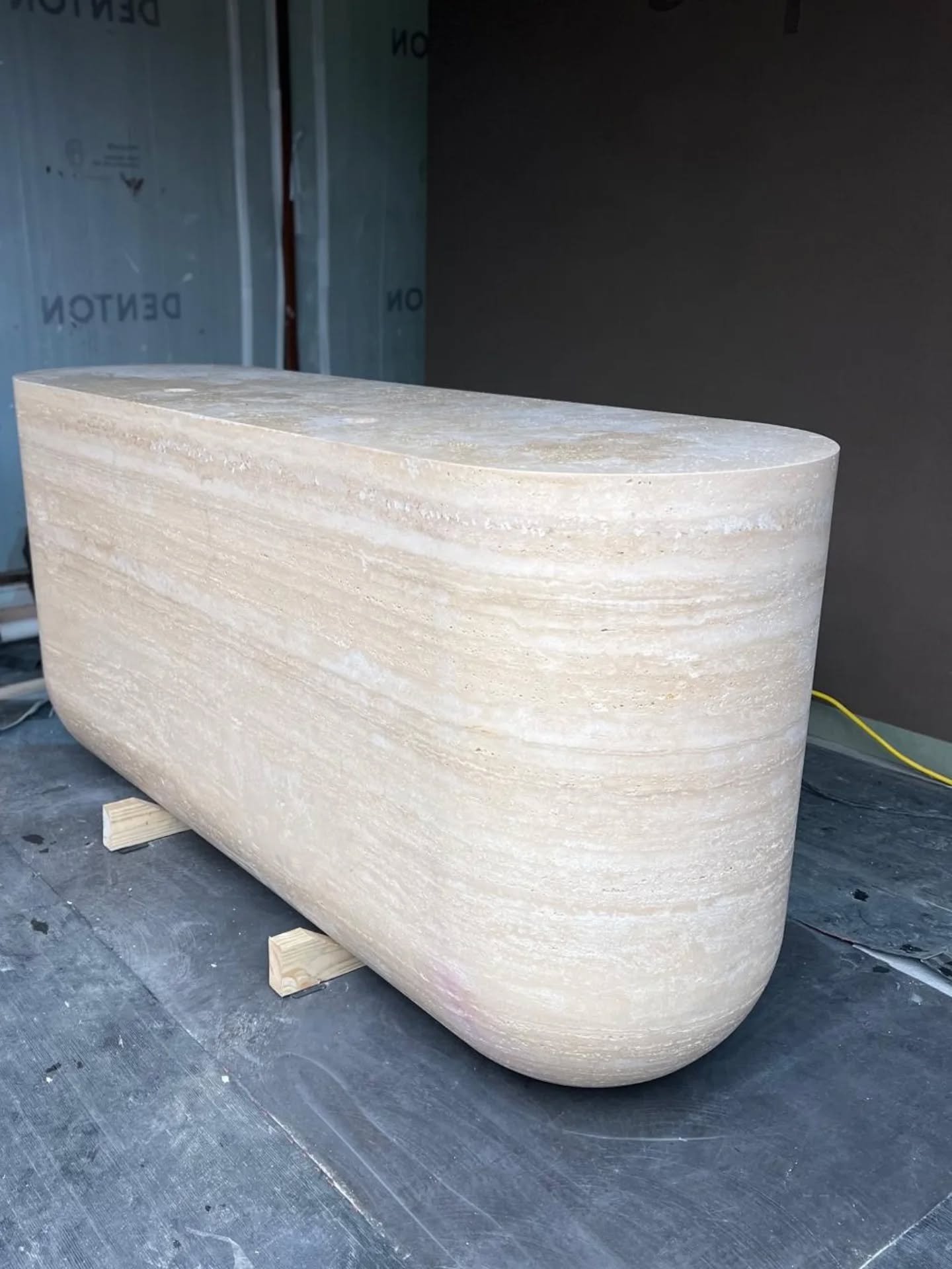 Seeing this one settle into position feels like a turning point.

What began as a solid block of Ivory Travertine is now in its final stages on site for @aspiredentalacademy, with the design by @szc_teh starting to fully reveal itself. 

The form is 