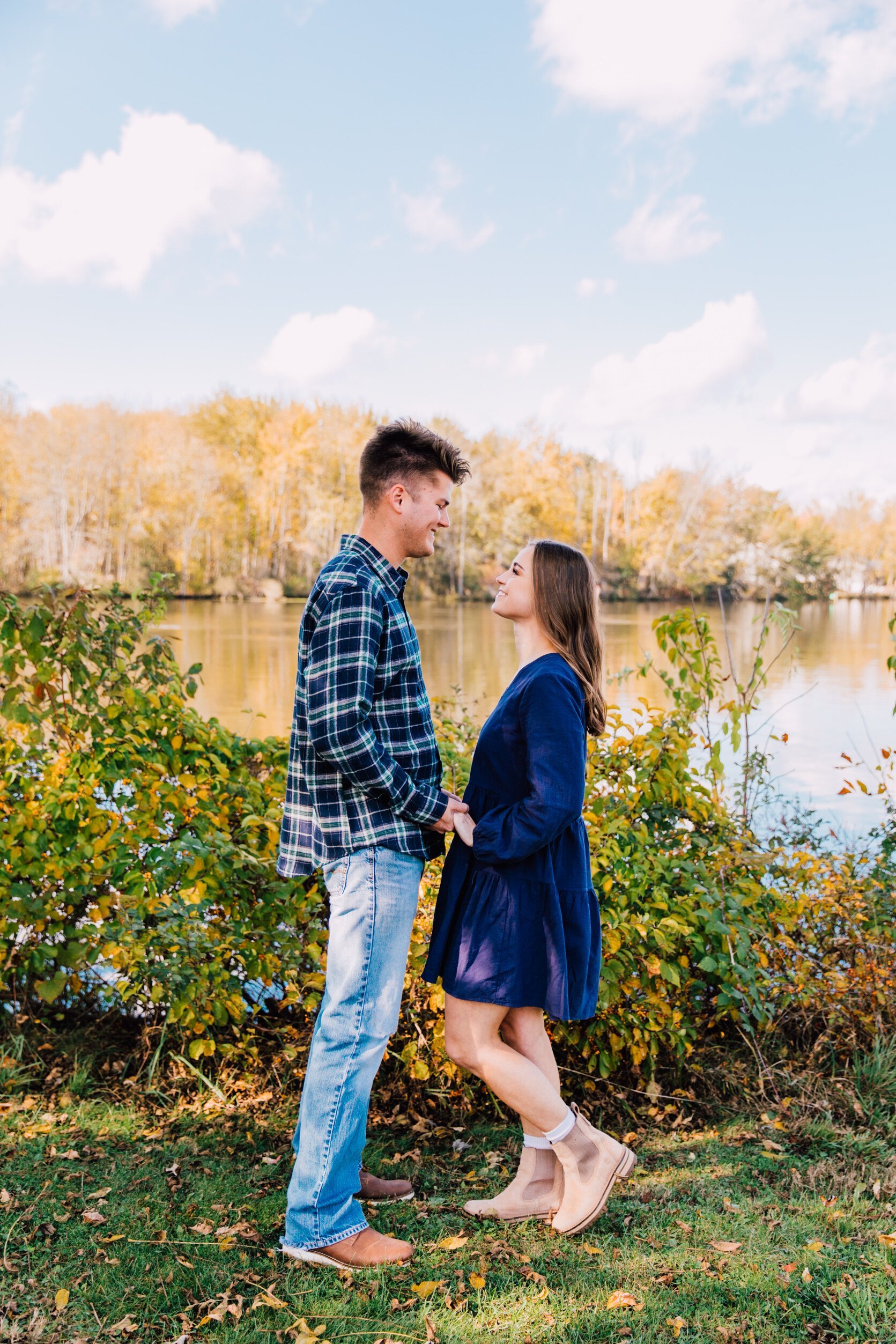  Syracuse, NY engagement photographer captures an engaged couple looking at each other on a bright sunny day 
