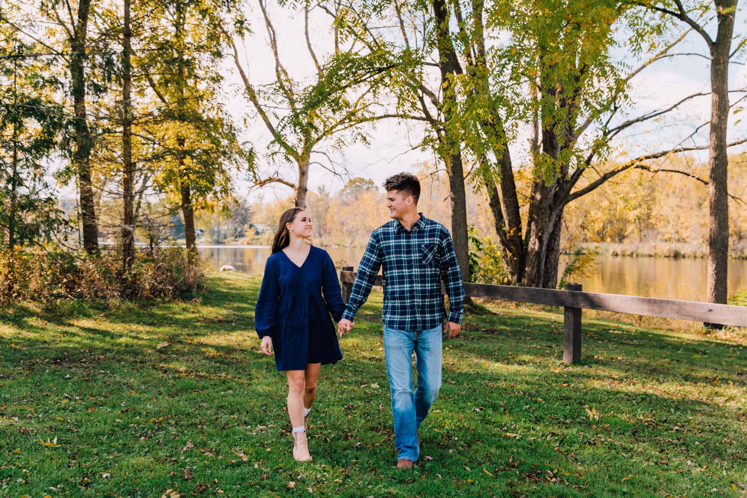  engaged couple walk together during a mini session in central ny   