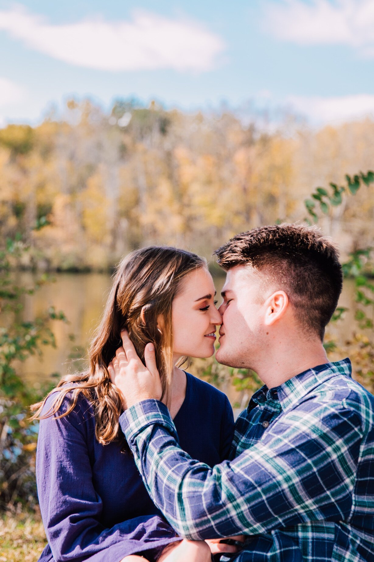  engaged couple smile as they kiss during their engagement session 