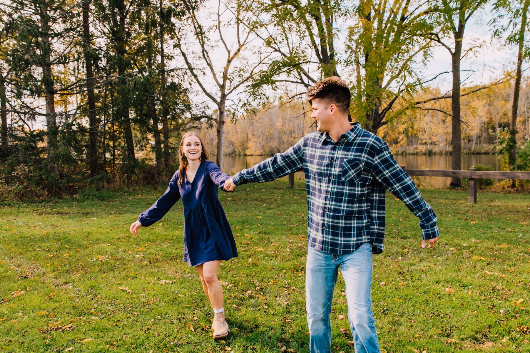  engaged couple swing each other lakefront in central NY 