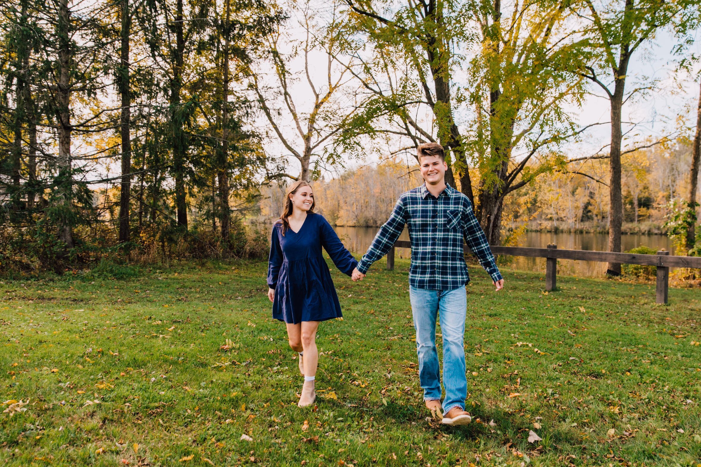  Syracuse, NY engagement photographer captures an engaged couple smiling hand in hand 