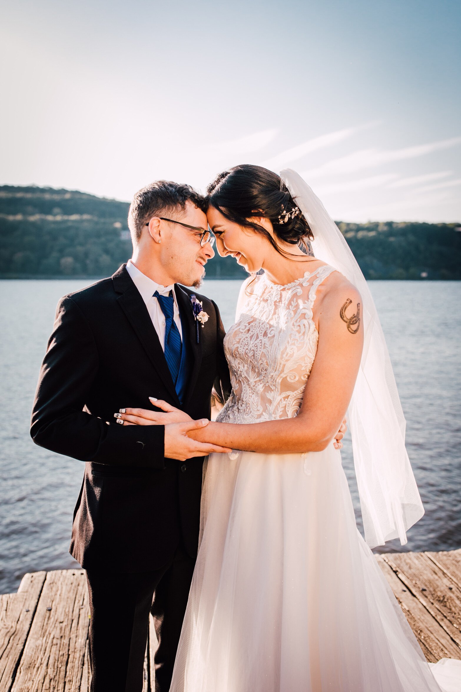  the bride and groom smile at each other during their hudson river wedding 