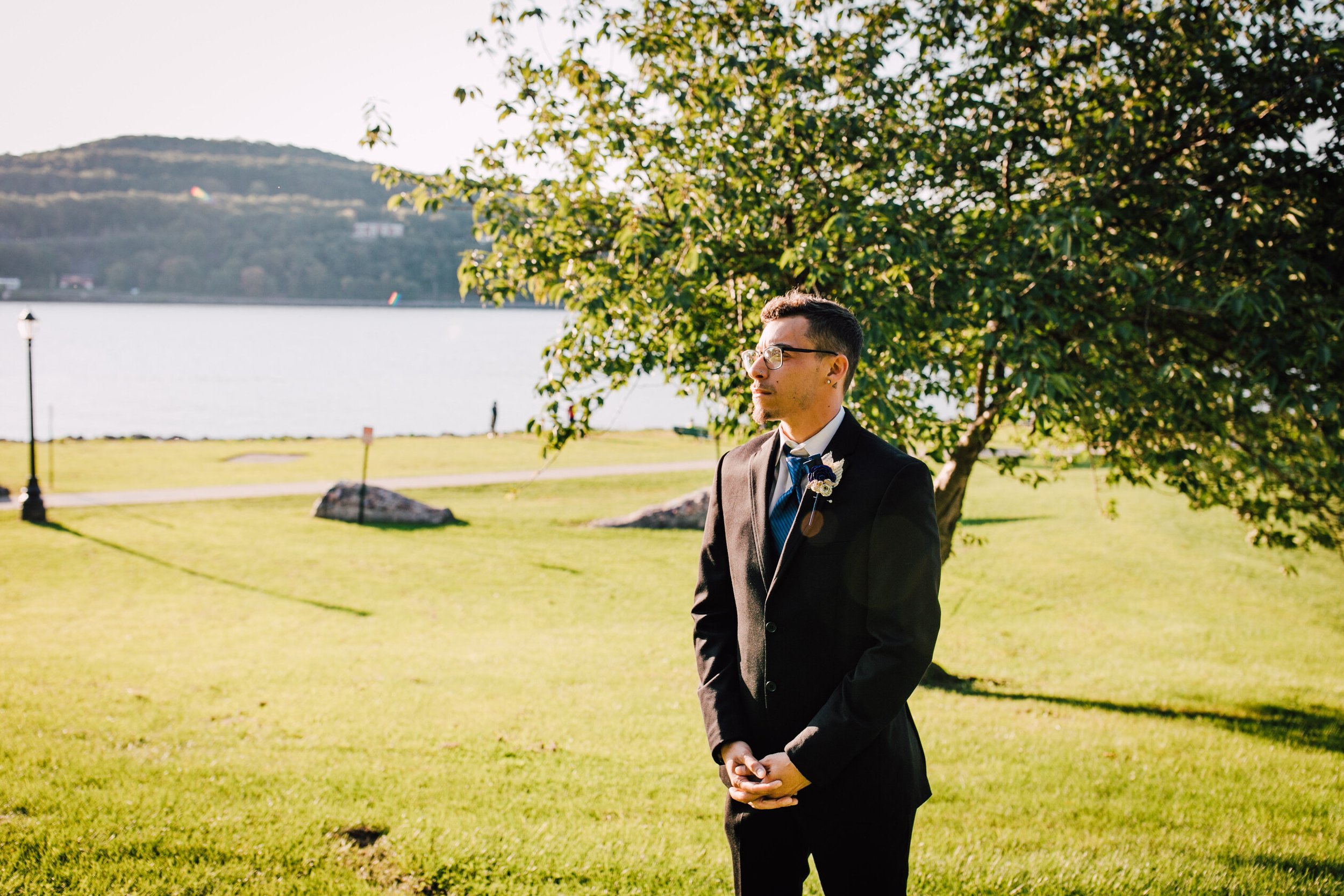  the groom waits for his first look at the couple’s hudson river wedding 