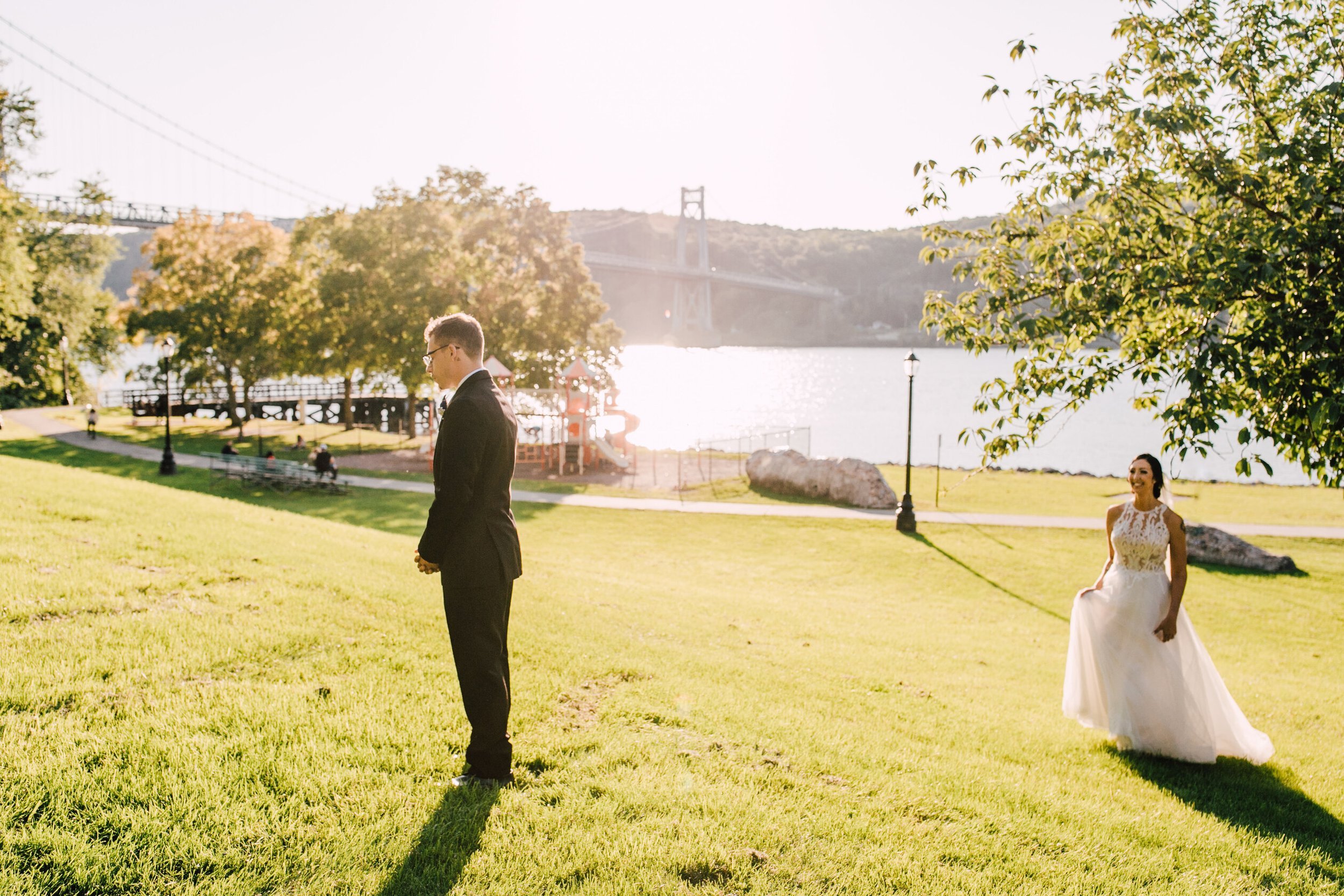  the bride walks up to the groom at their hudson river wedding first look 