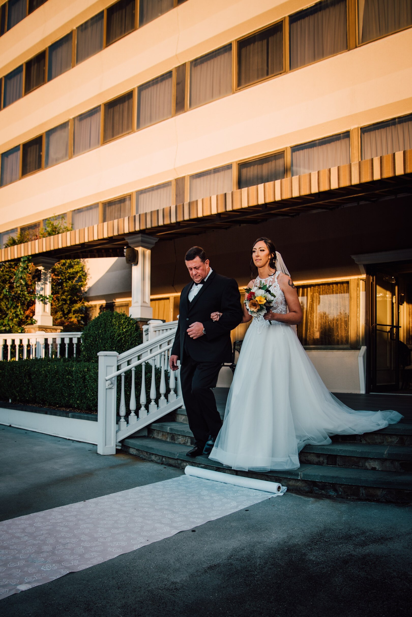 the bride walks down the aisle with her father at her poughkeepsie grand hotel wedding 