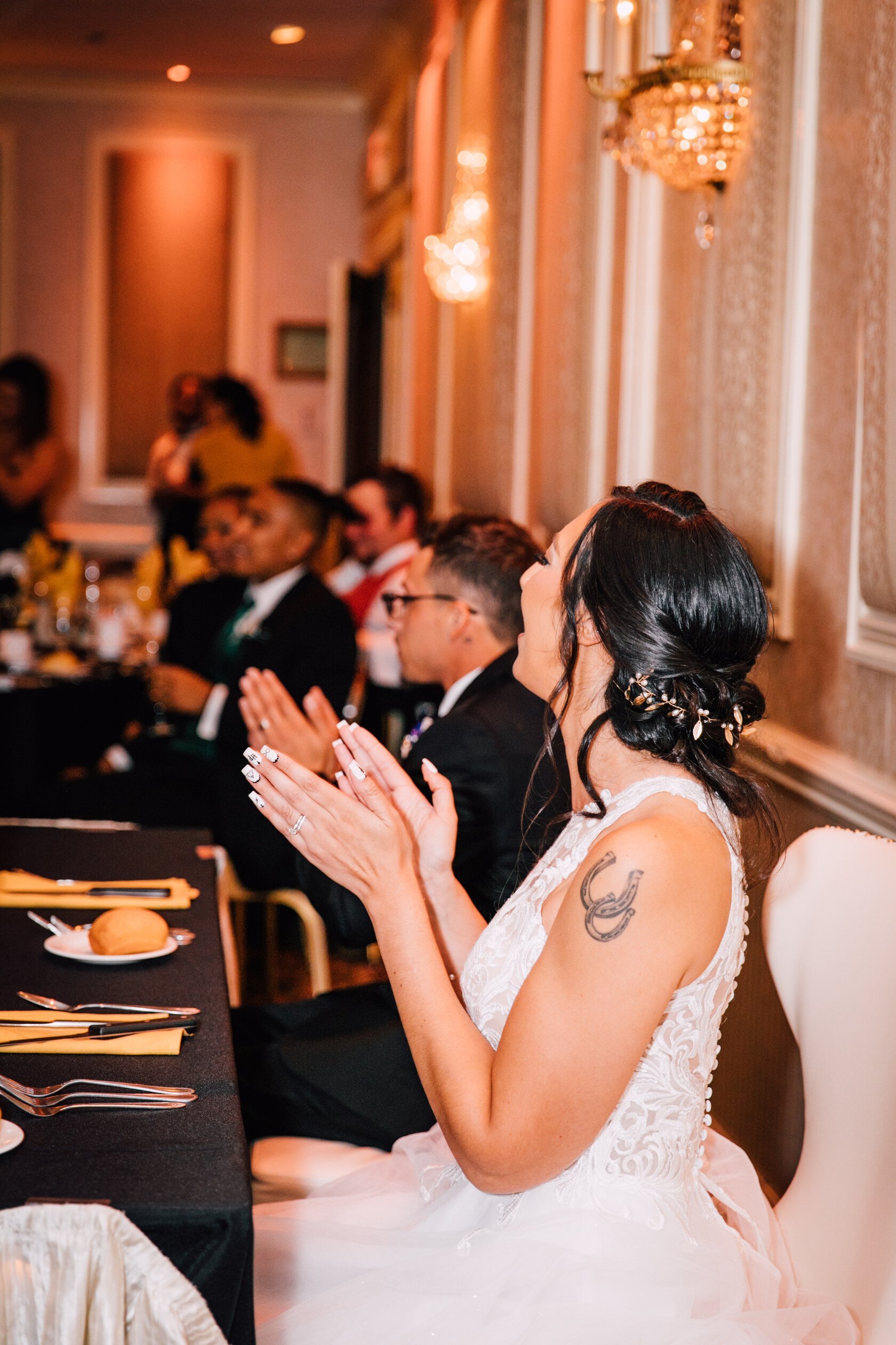  the bride claps during the toasts at her poughkeepsie grand hotel wedding reception 
