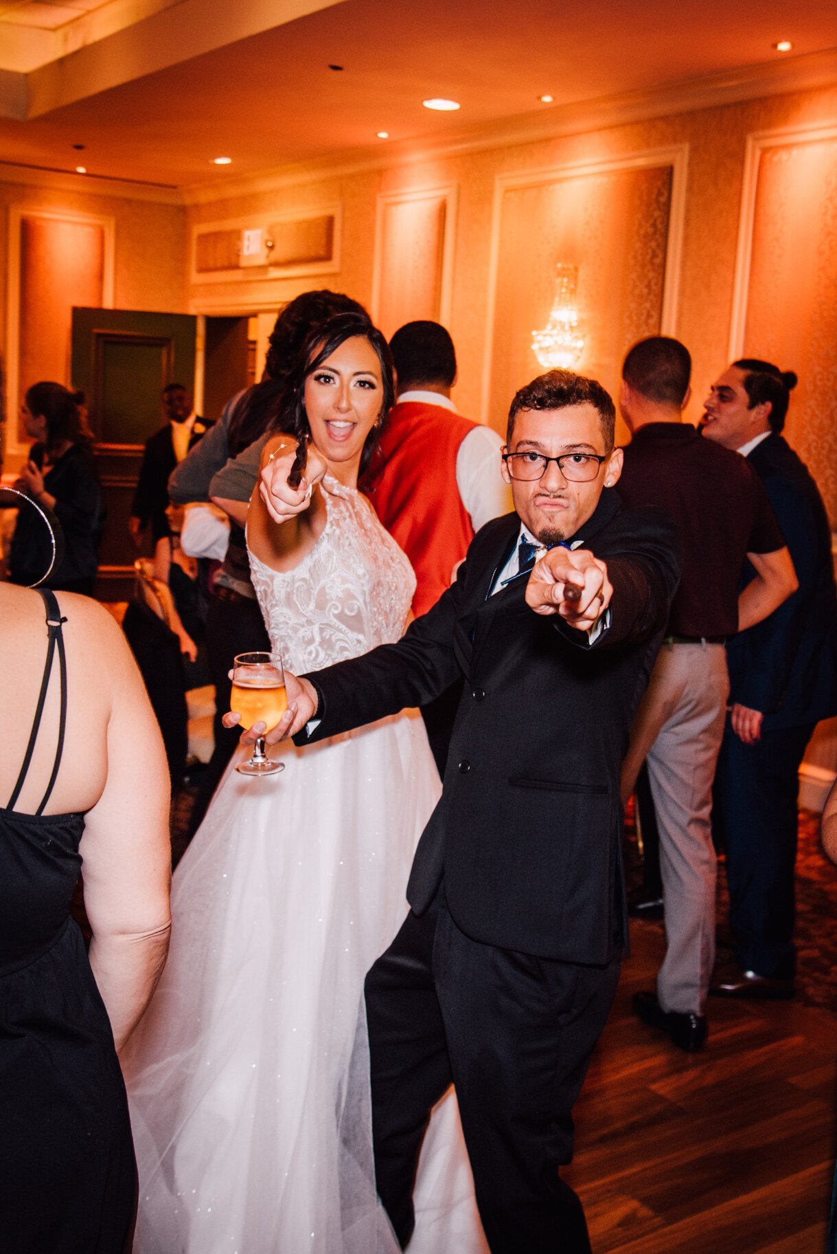  the bride and groom pose with their wands at their harry potter wedding reception 