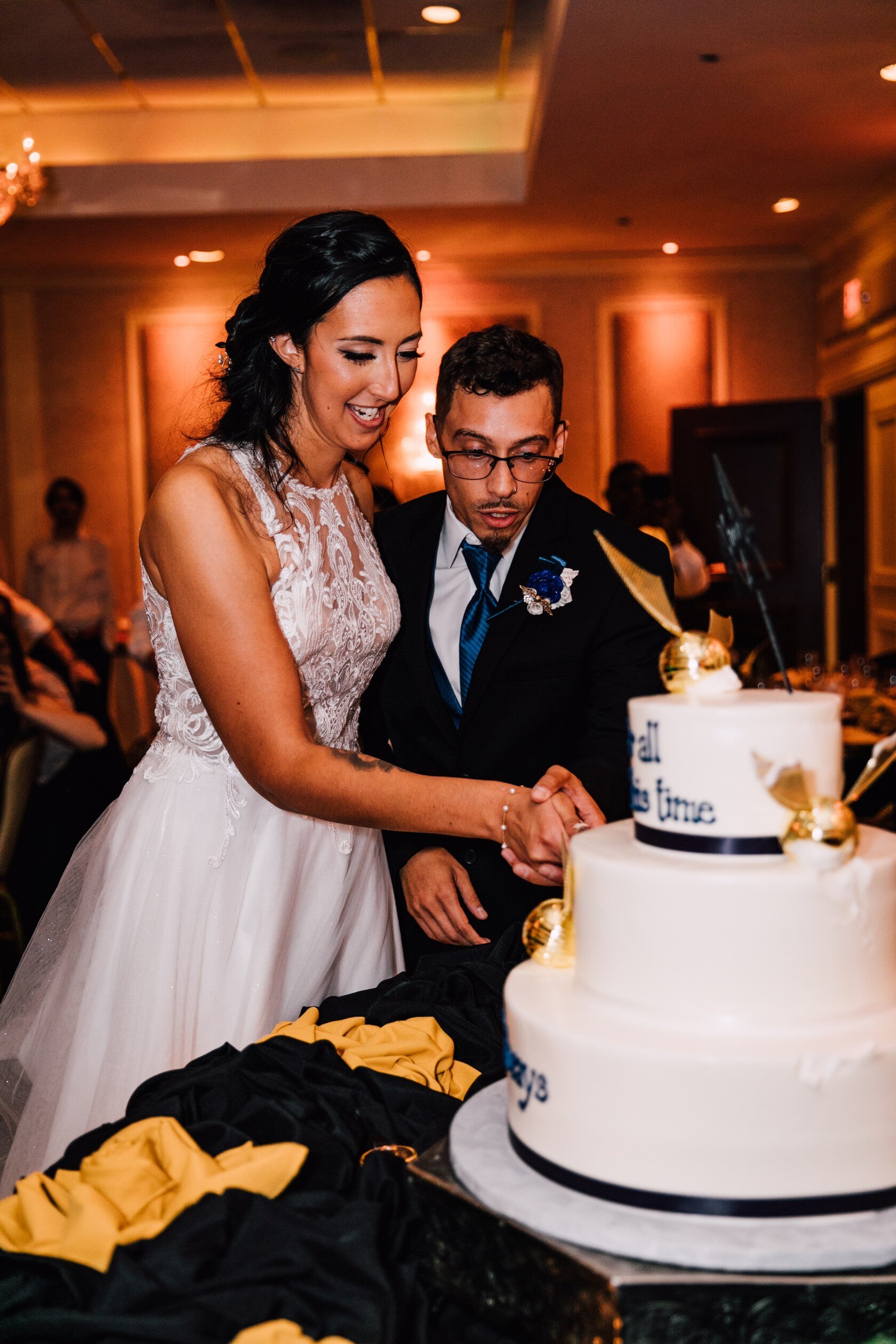  the newlyweds cut their harry potter wedding cake  