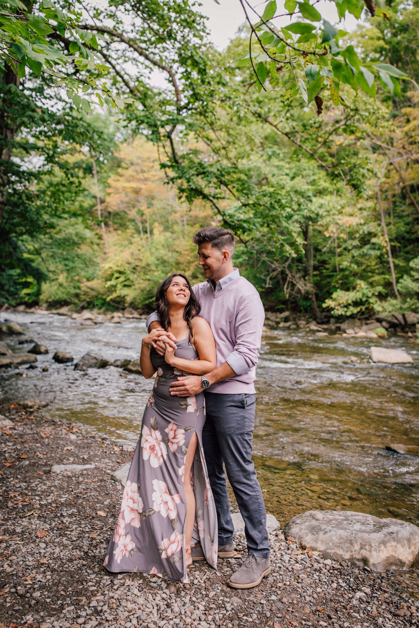  Engaged couple dance in front of flowing water, waterfall engagement photos 