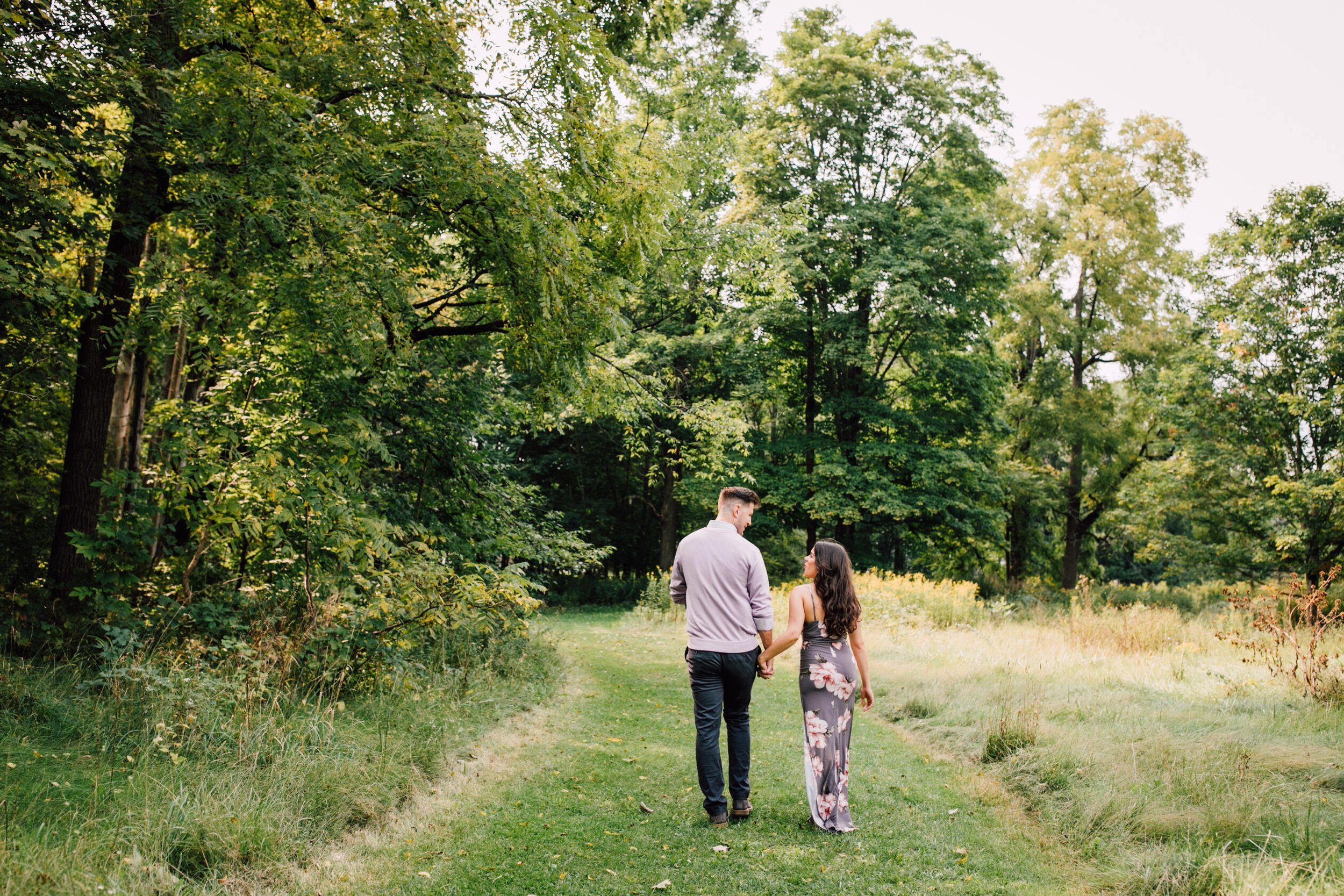  Engaged couple walk hand in hand into the woods at chittenango falls, waterfall engagement photos 