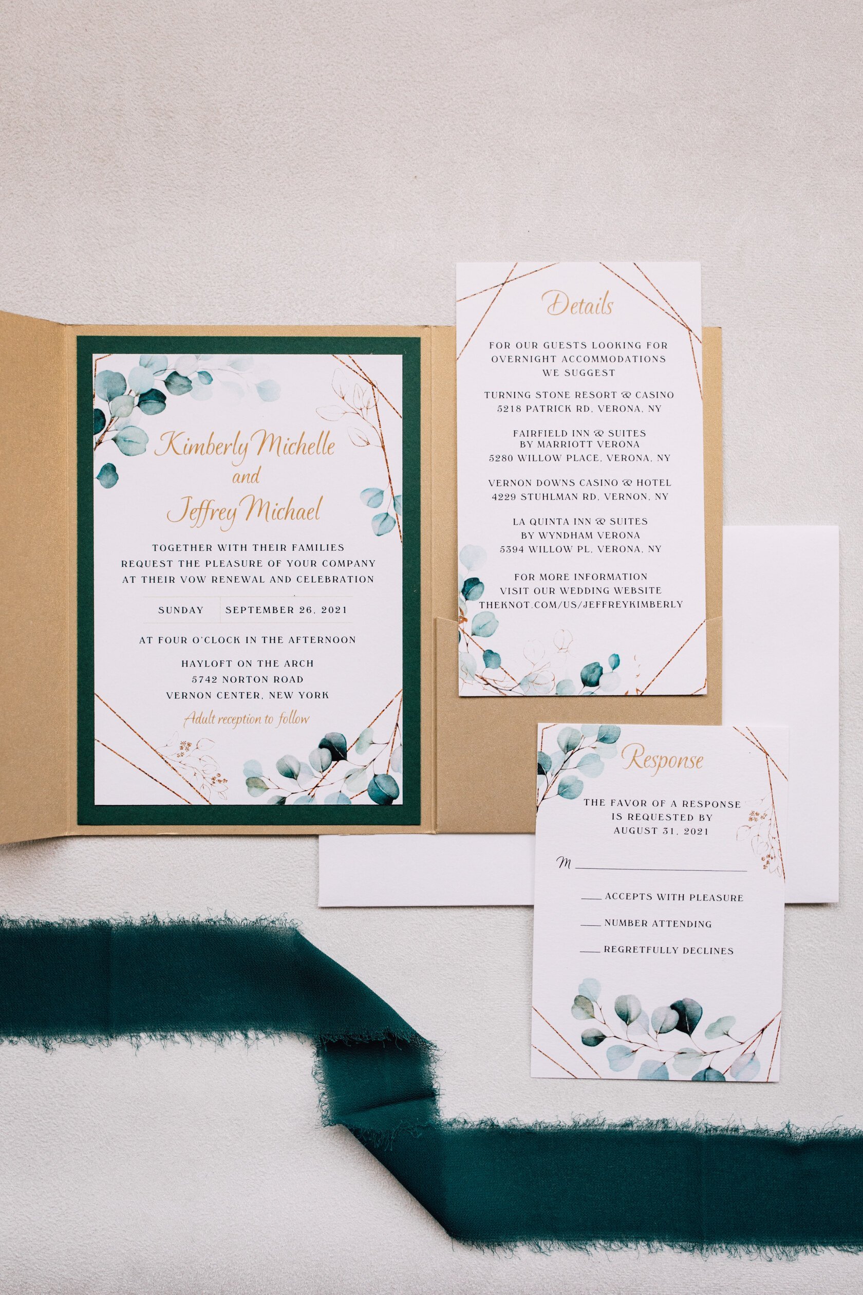  Wedding stationary lays flat showing its green and gold details 