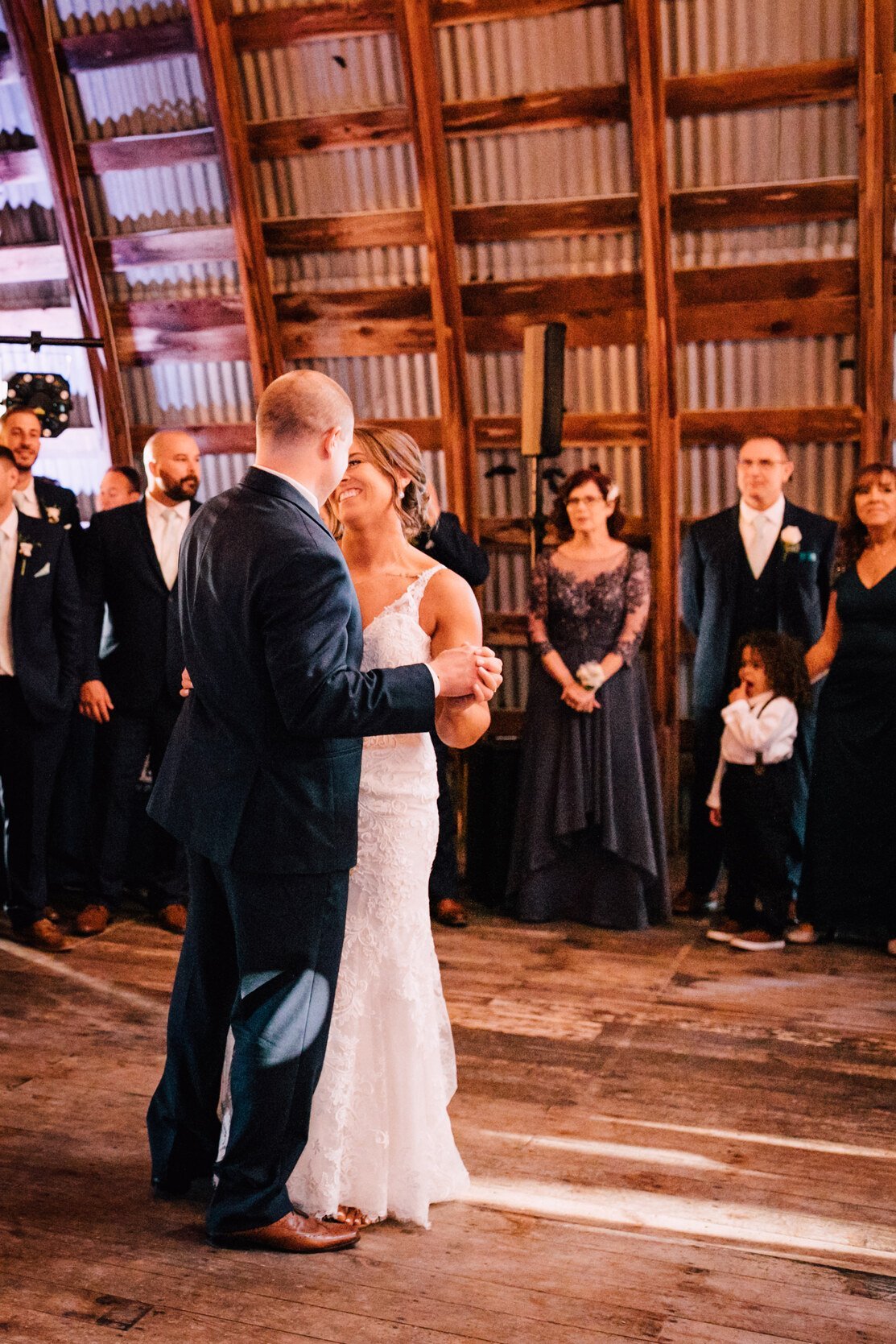  The bride and groom share their first dance at their barn wedding 