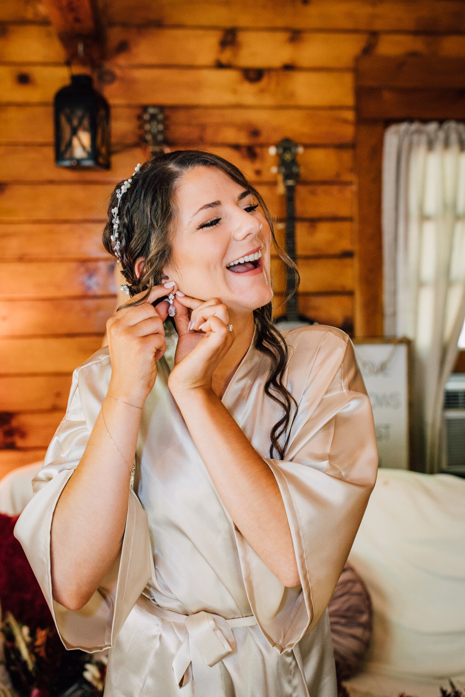  Bride fastens her earring before her outdoor fall wedding 