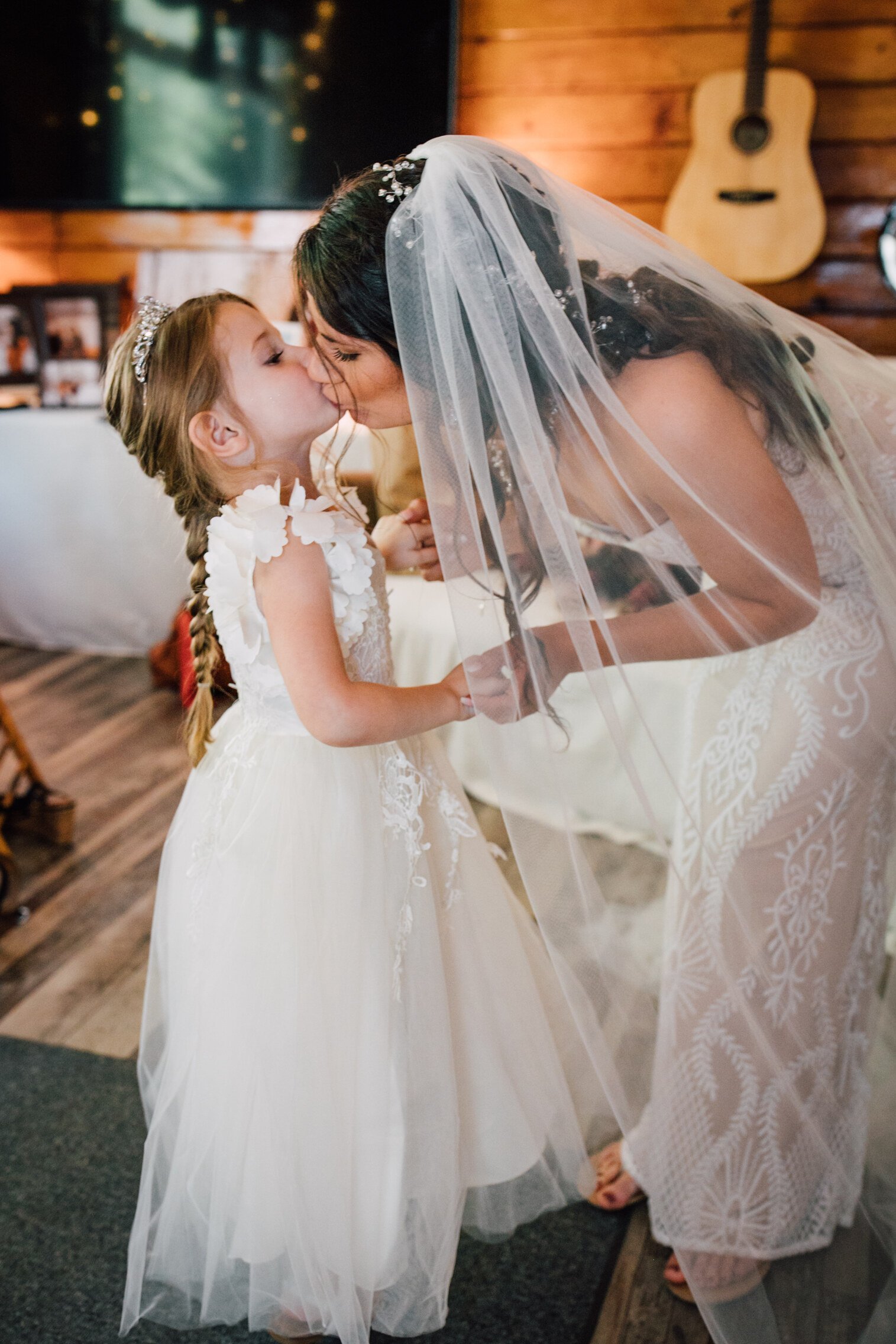  Bride-to-be kisses her daughter before her backyard wedding ceremony 