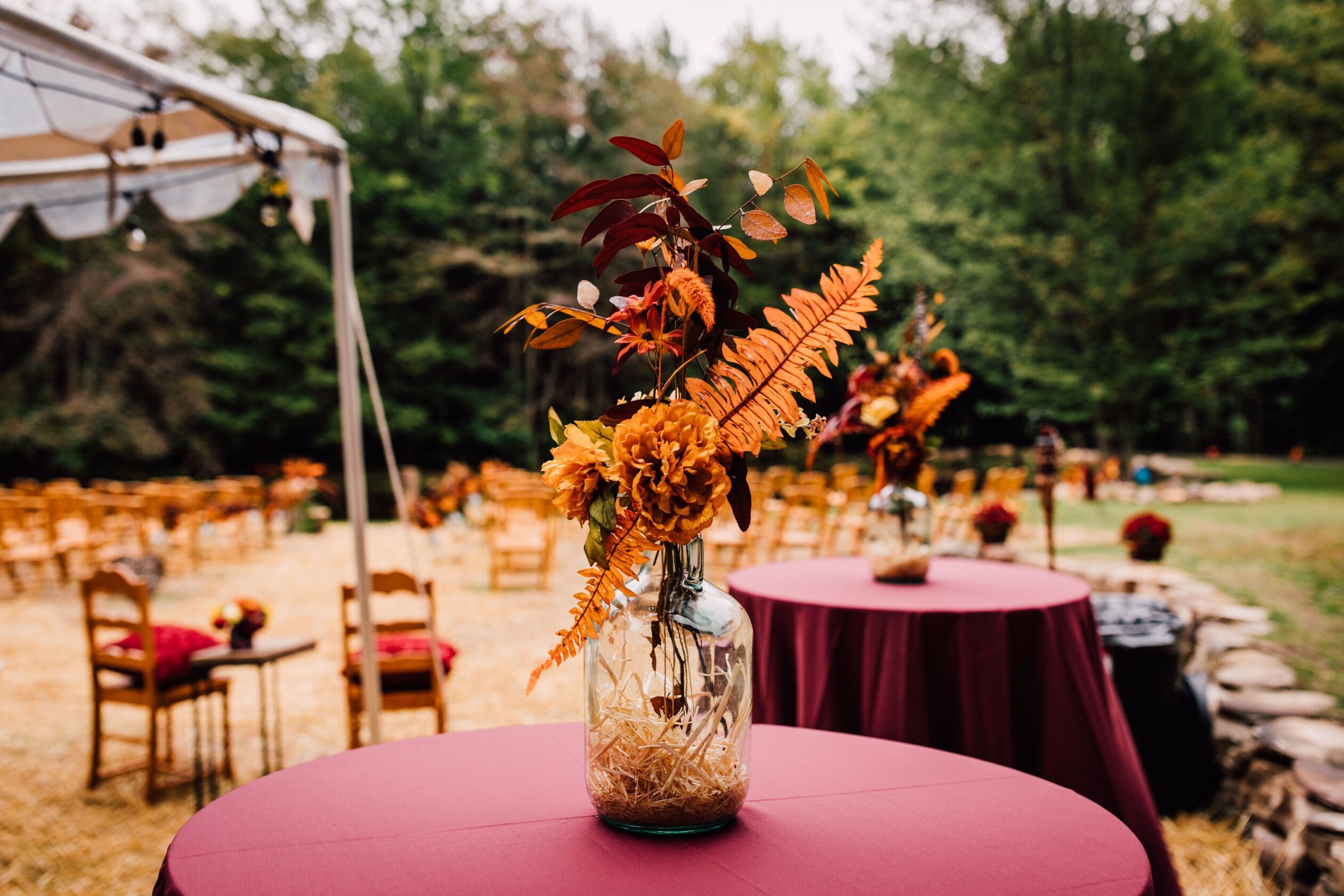  A dried floral arrangement sits on a table as part of the backyard wedding decor 