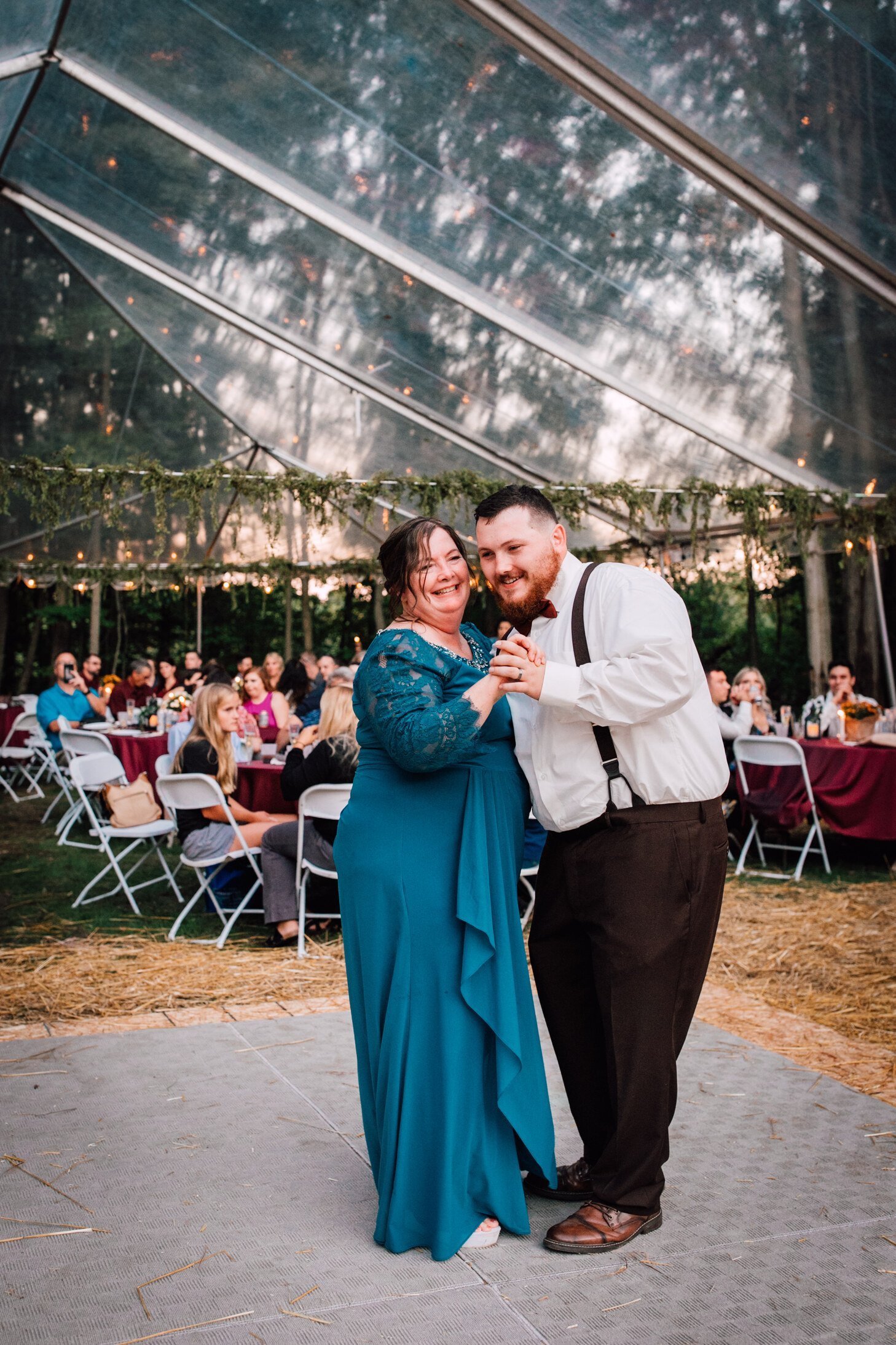  The groom dances with his mother at his outdoor fall wedding 