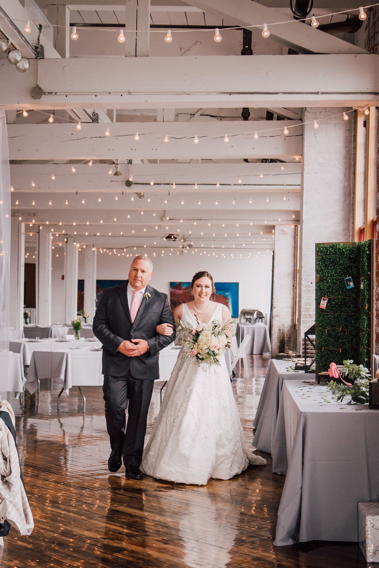  Bride walks down the aisle with her father at her cracker factory wedding ceremony&nbsp; 