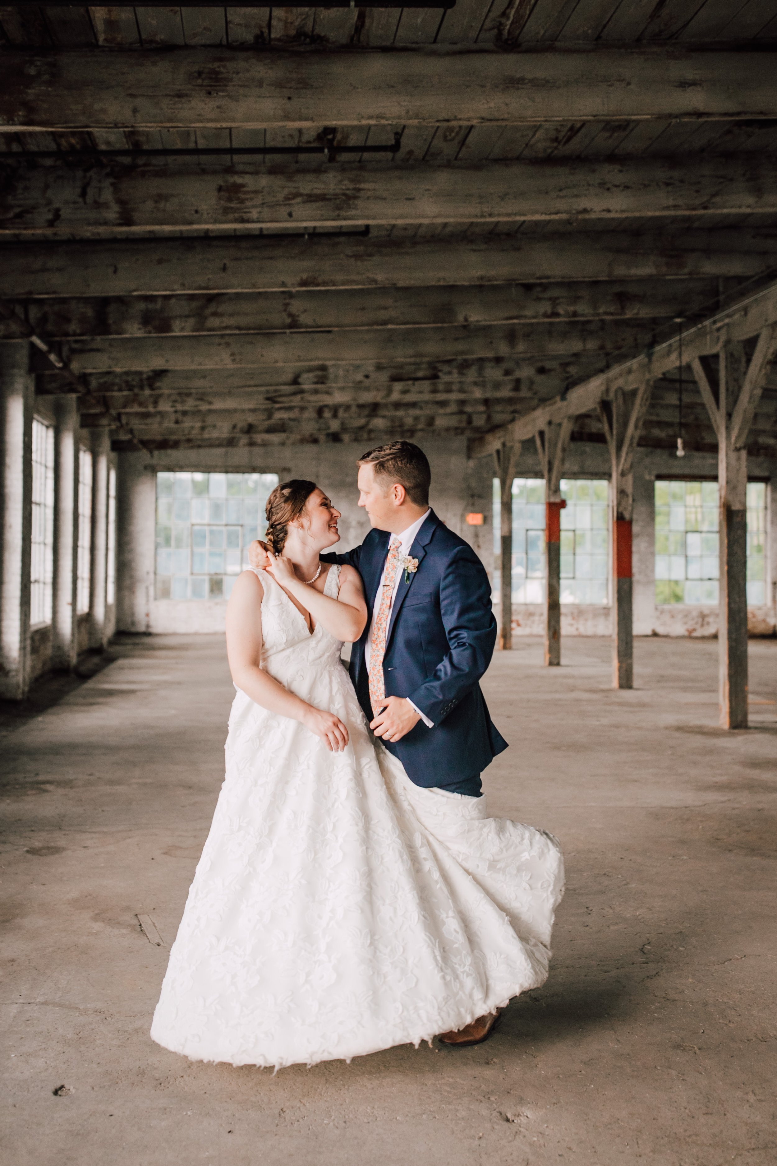  Bride and groom dance at their industrial wedding venue 