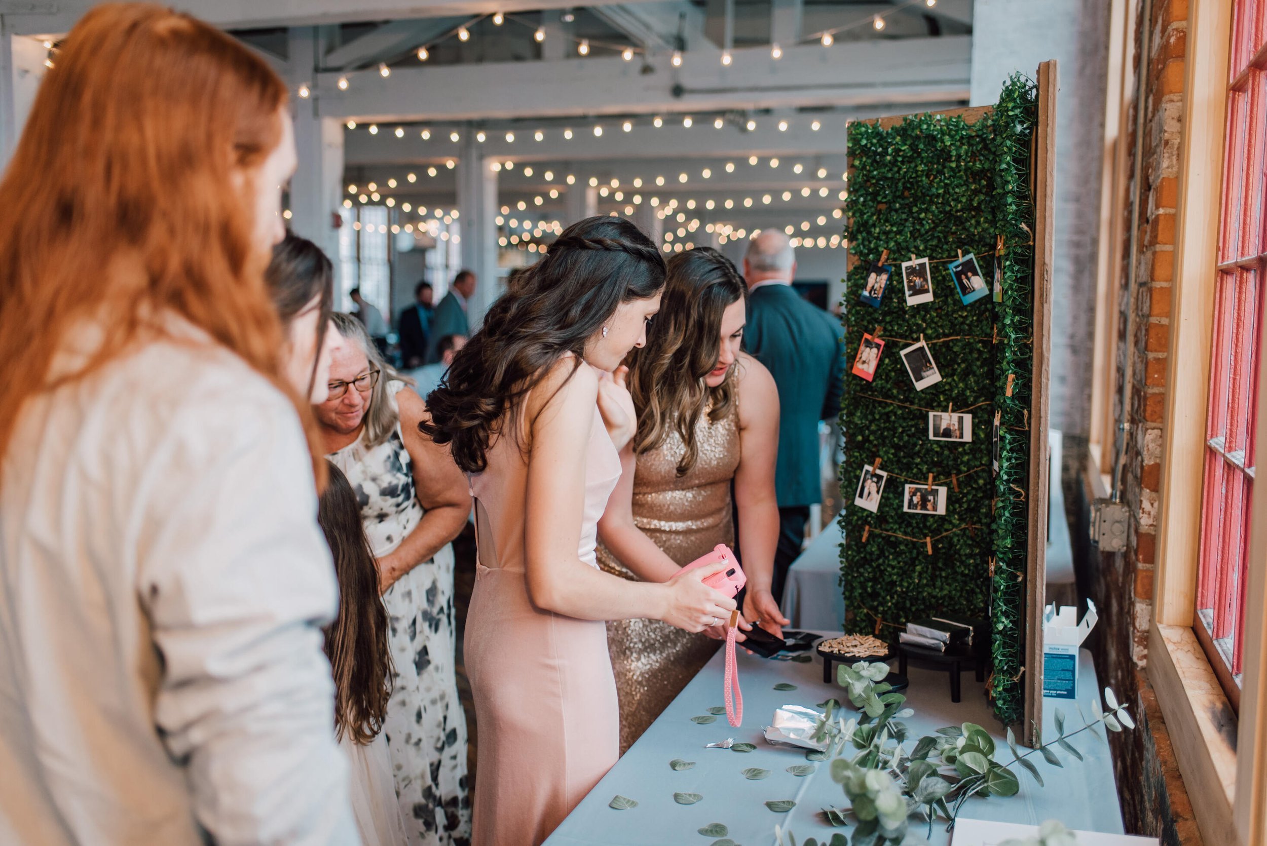  Guests fill out the Polaroid guestbook at a cracker factory wedding&nbsp; 
