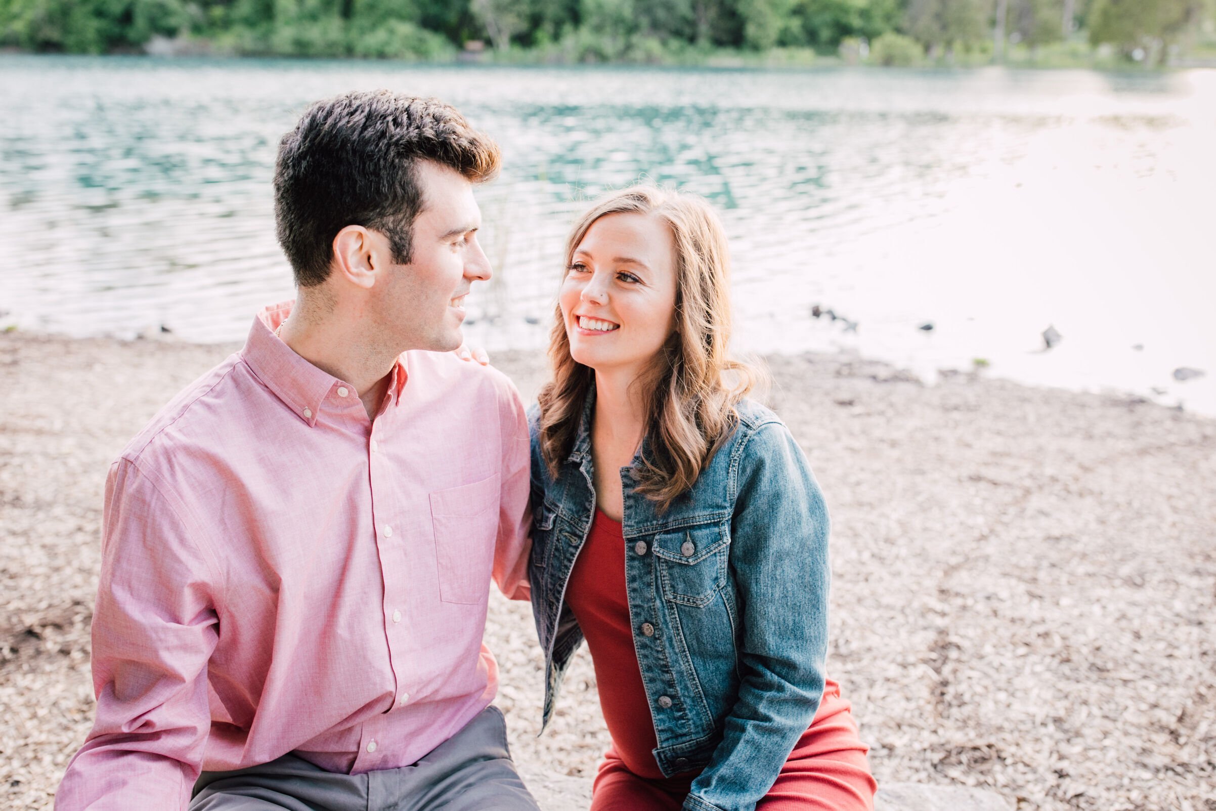  Parents to be smile at each other during pregnancy announcement photo shoot 