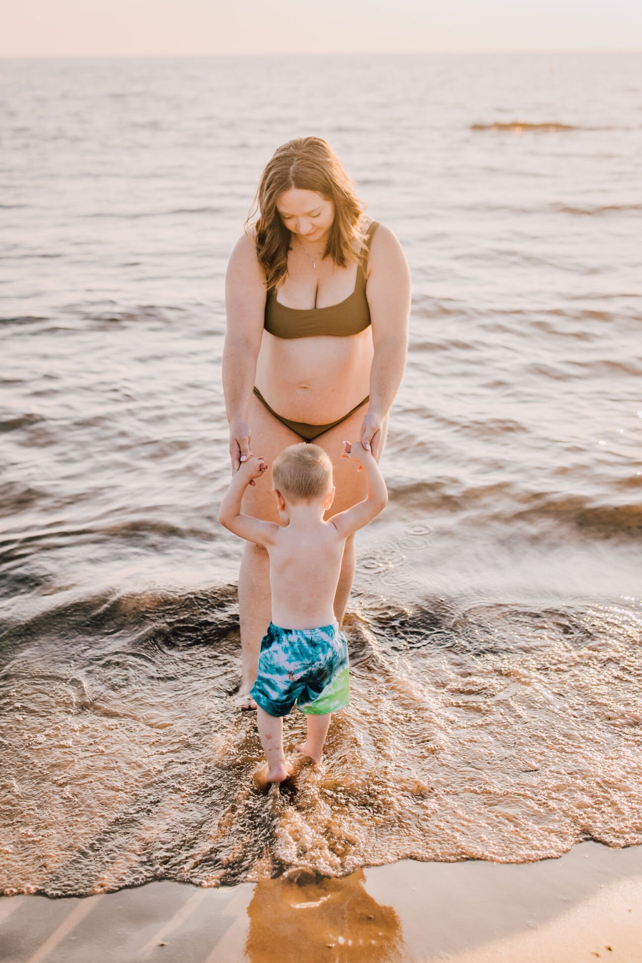  A pregnant mom helps her son walk at southwick beach, mommy and me session 