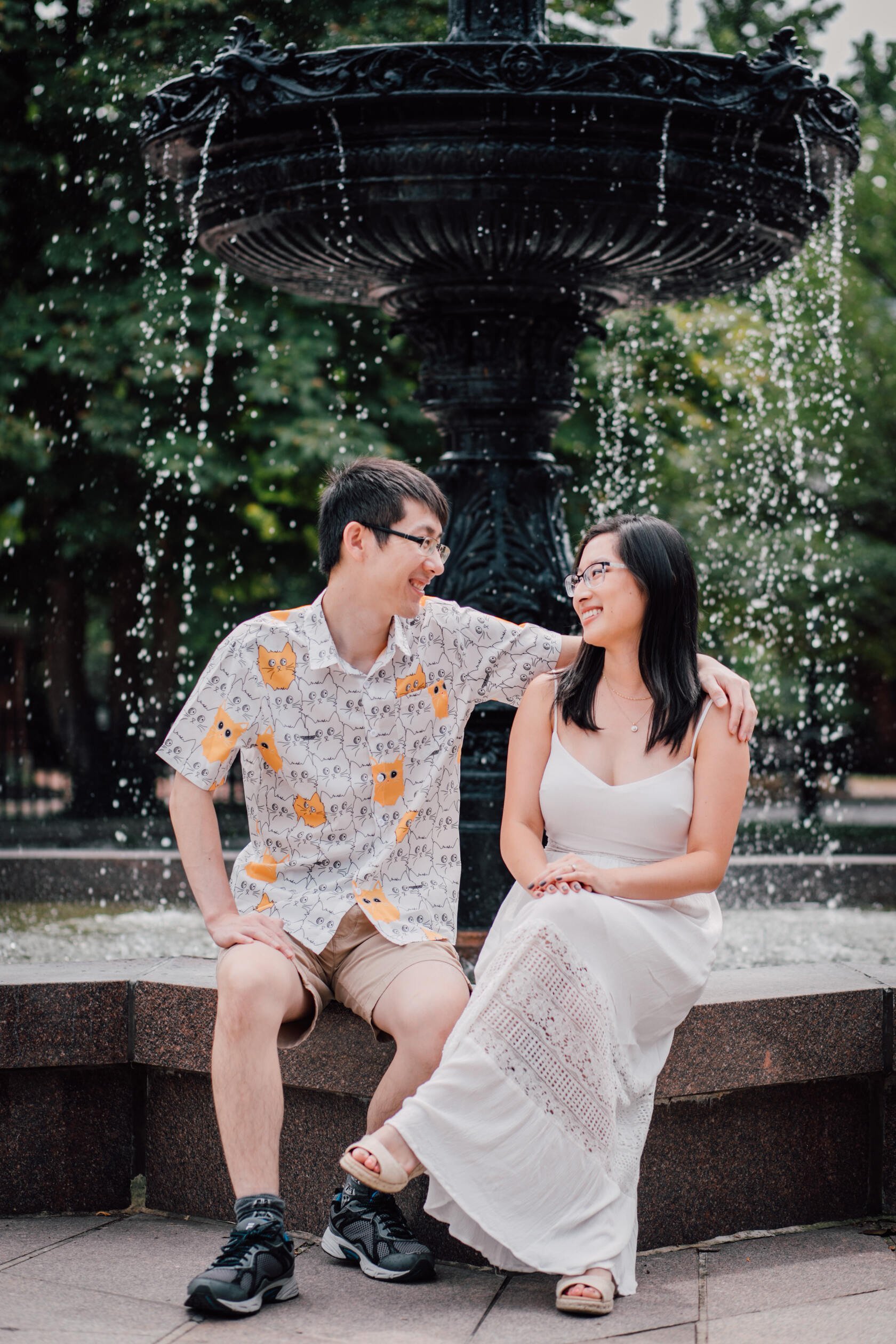  A couple sits in front of a water fountain, downtown Syracuse&nbsp; 