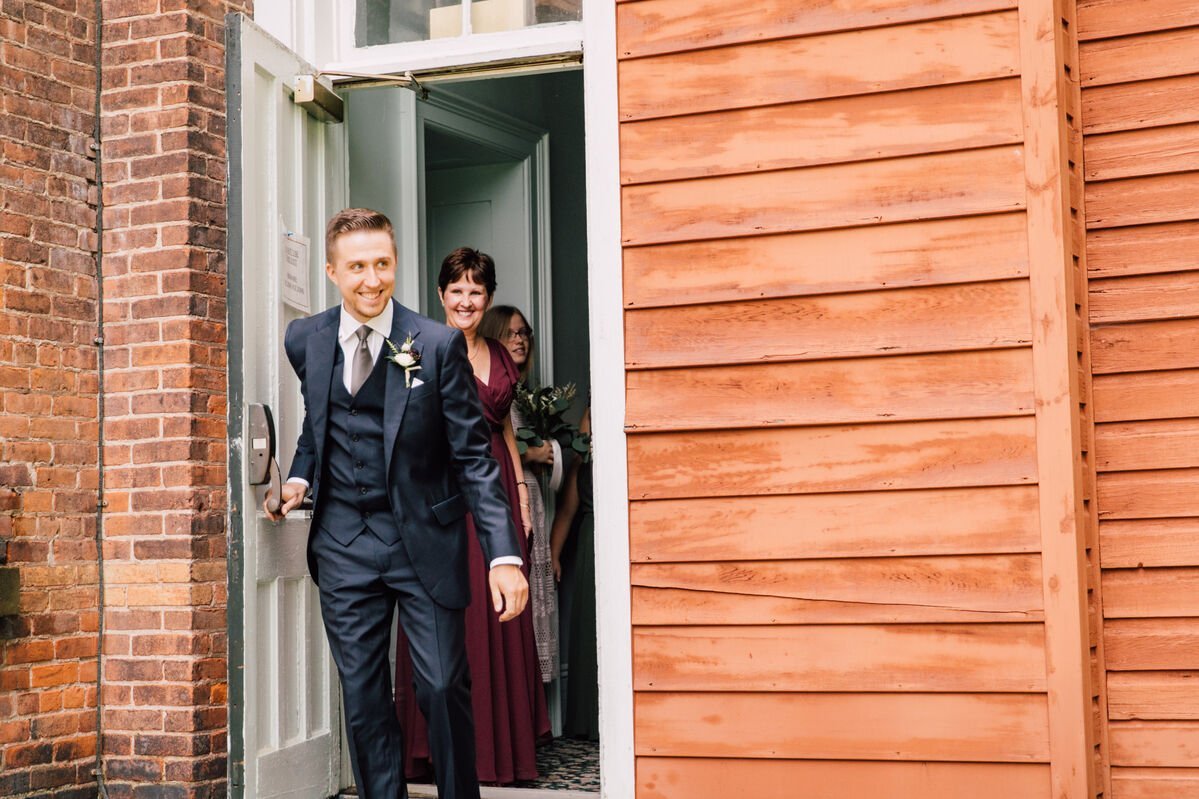 groom walks excitedly toward his bride to be during their garden wedding first look 