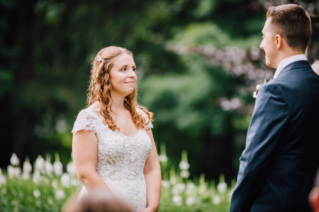  Bride and groom look at each other during their outdoor wedding ceremony 