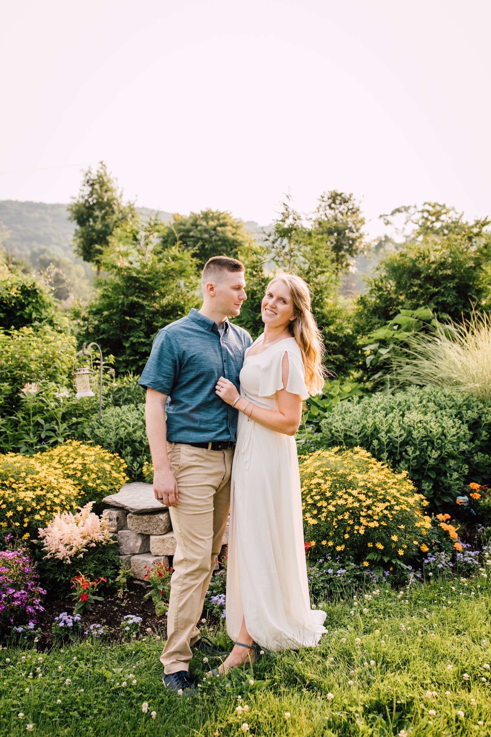  Jake looks at his fiancé while she smiles during their farm engagement photos 