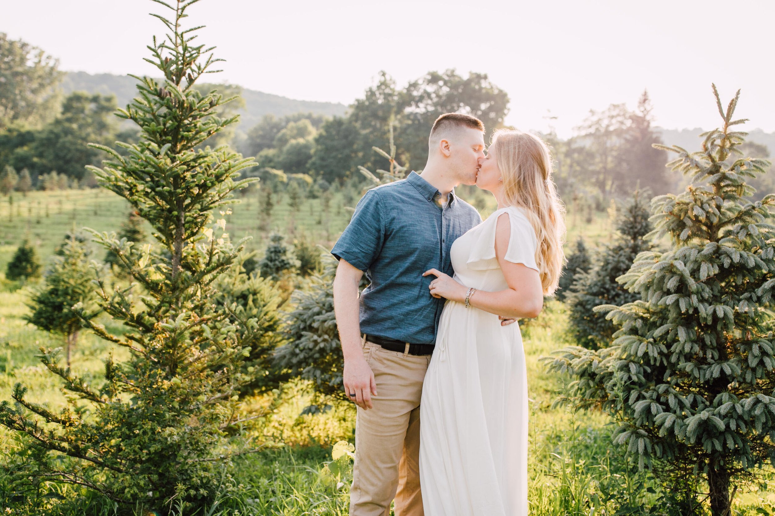  Engaged couple kiss for Christmas tree farm photos 