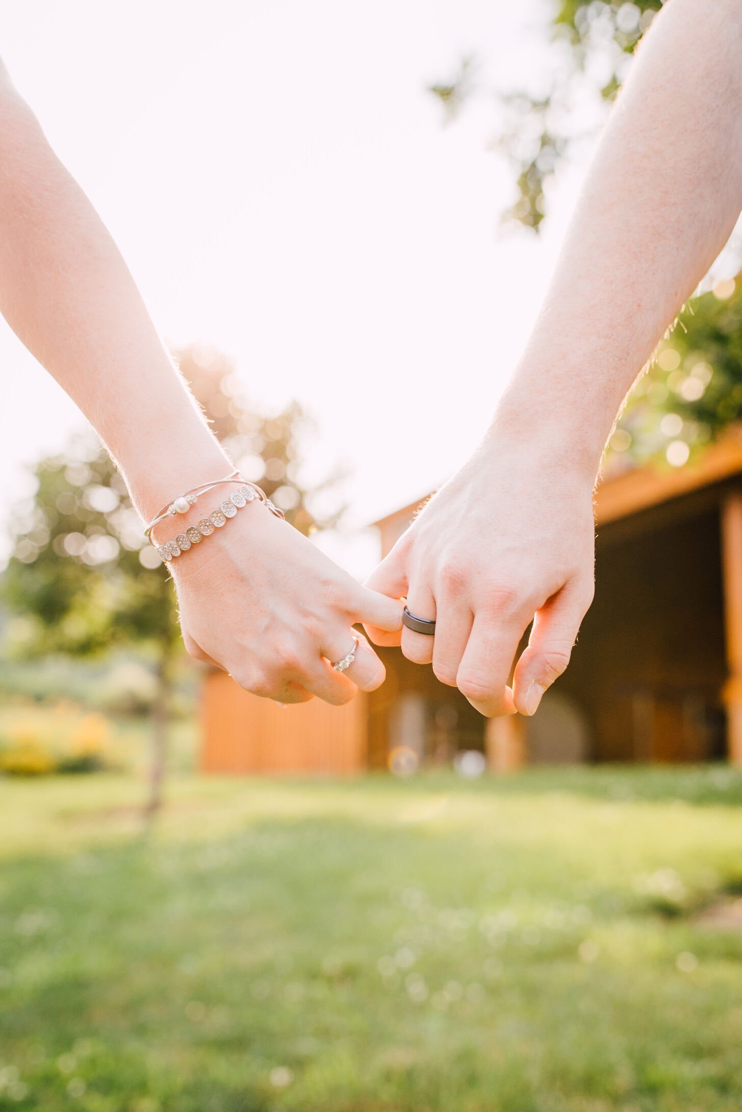  Engaged couples pinky promise while showing their rings for their farm engagement photos&nbsp; 