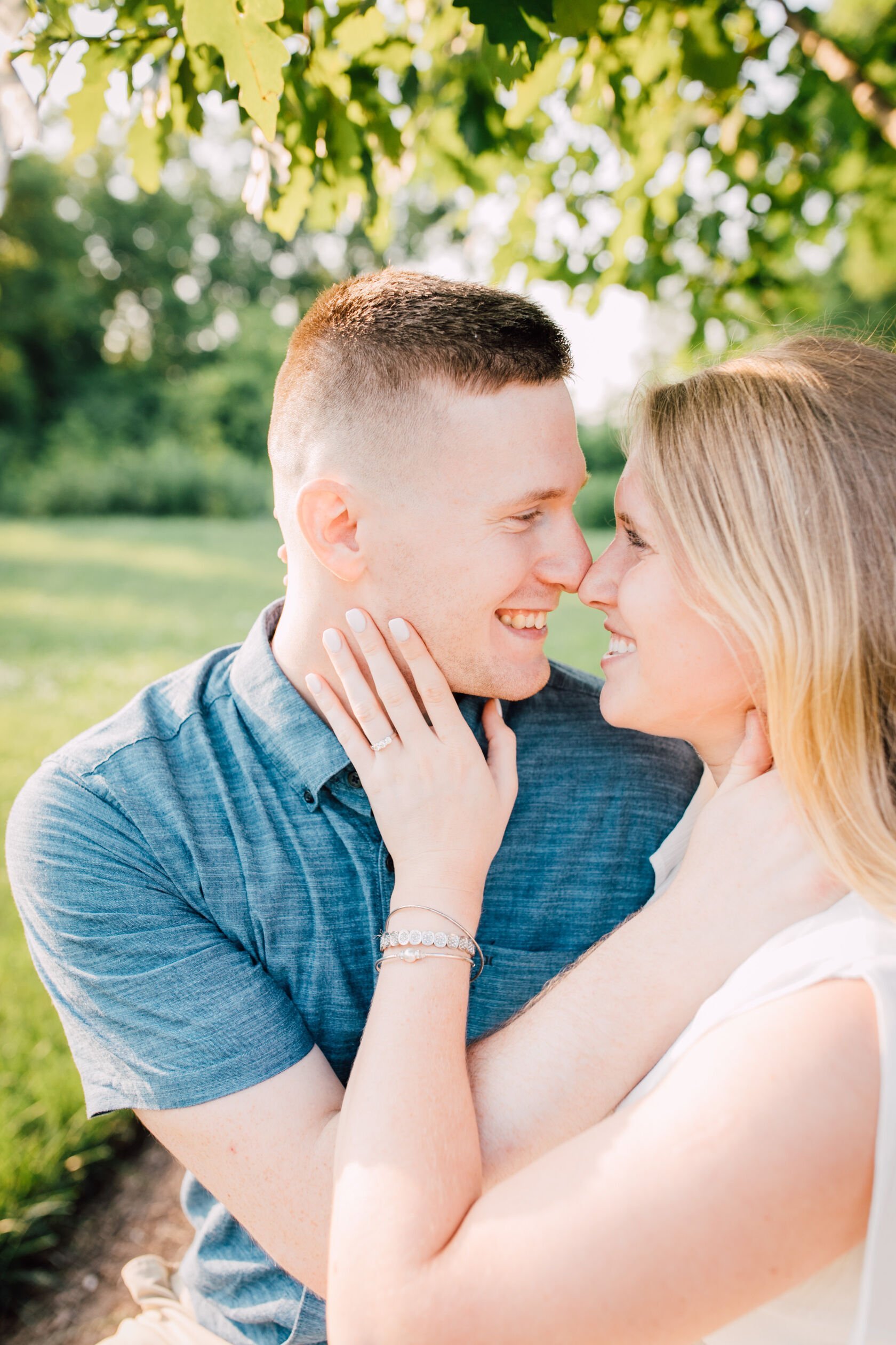  Smiles are wide as this engaged couple touch noses during farm engagement photos 