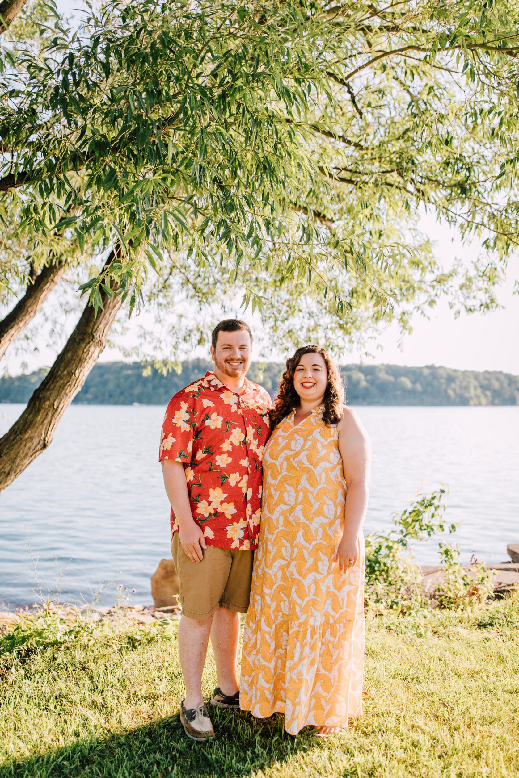  Hanna and Brandon stand together for lakefront photography at Lake Ontario for their engagement 