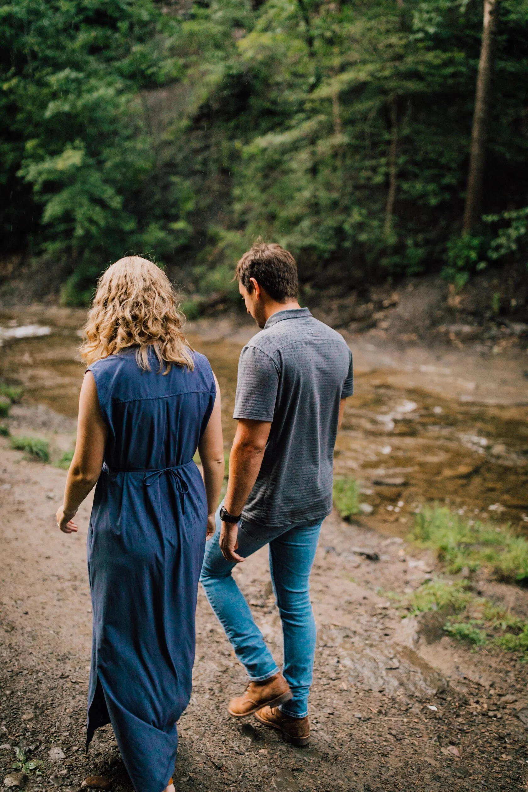  Engaged couple walk side by side at Delphi falls 