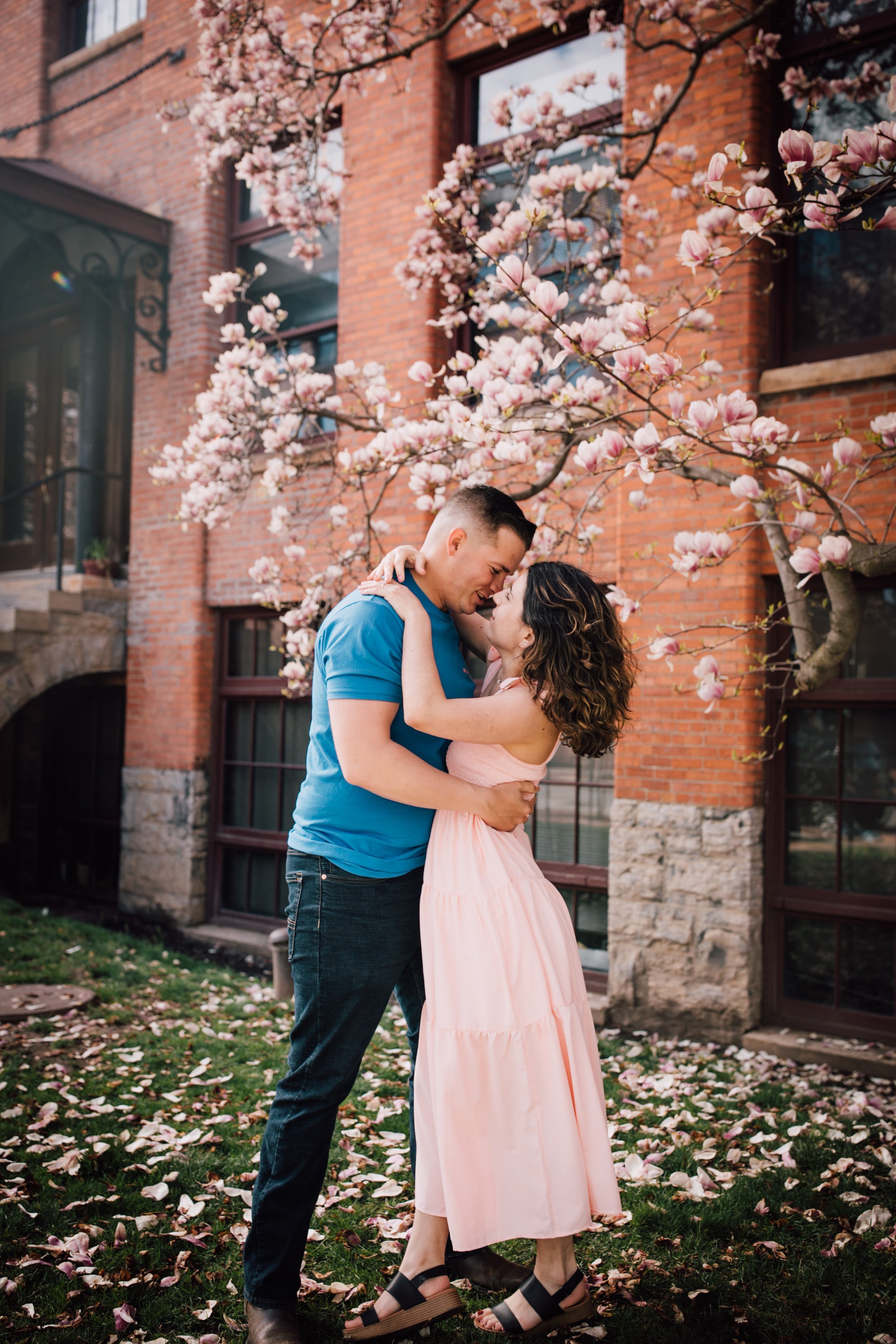  engaged couple in an embrace during engagement portraits in downtown syracuse 