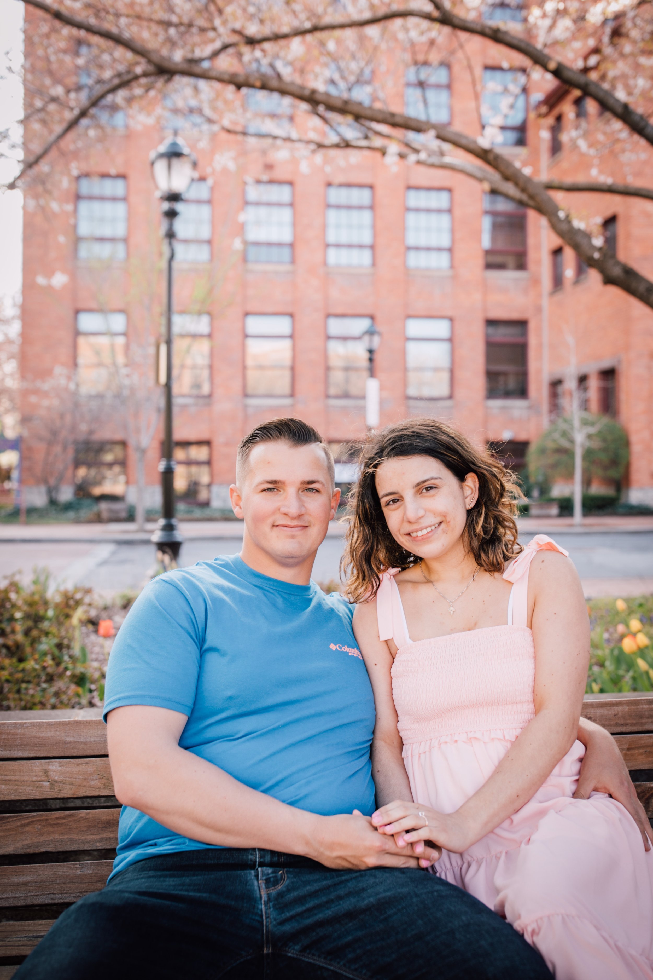  engaged couple look at camera during downtown syracuse engagement photoshoot 